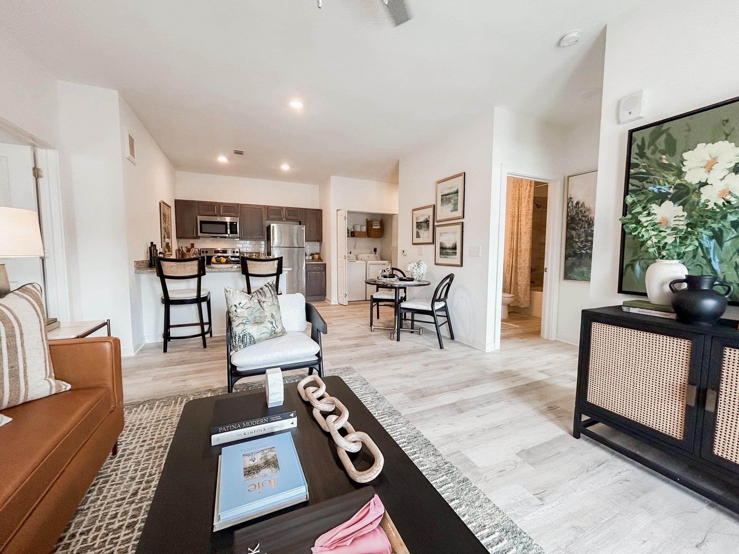 A living room with a couch, coffee table, and a painting on the wall.