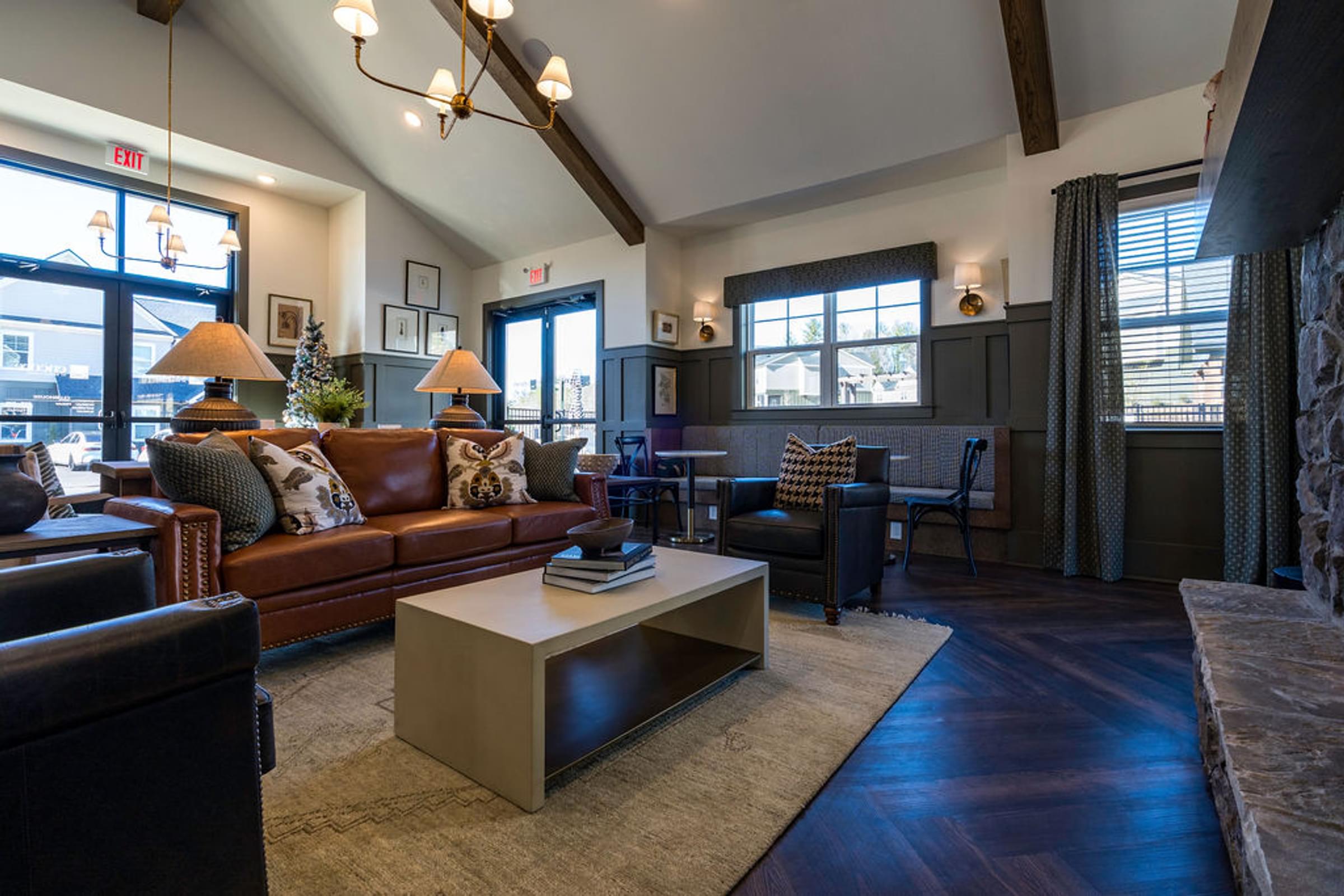 A living room with a brown couch and a coffee table.