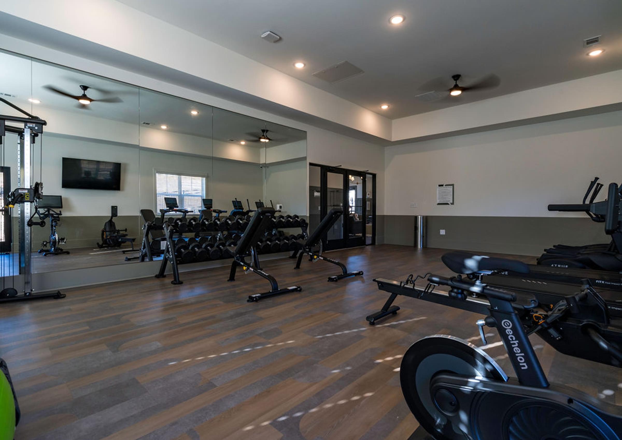 A spacious gym with a variety of exercise equipment.