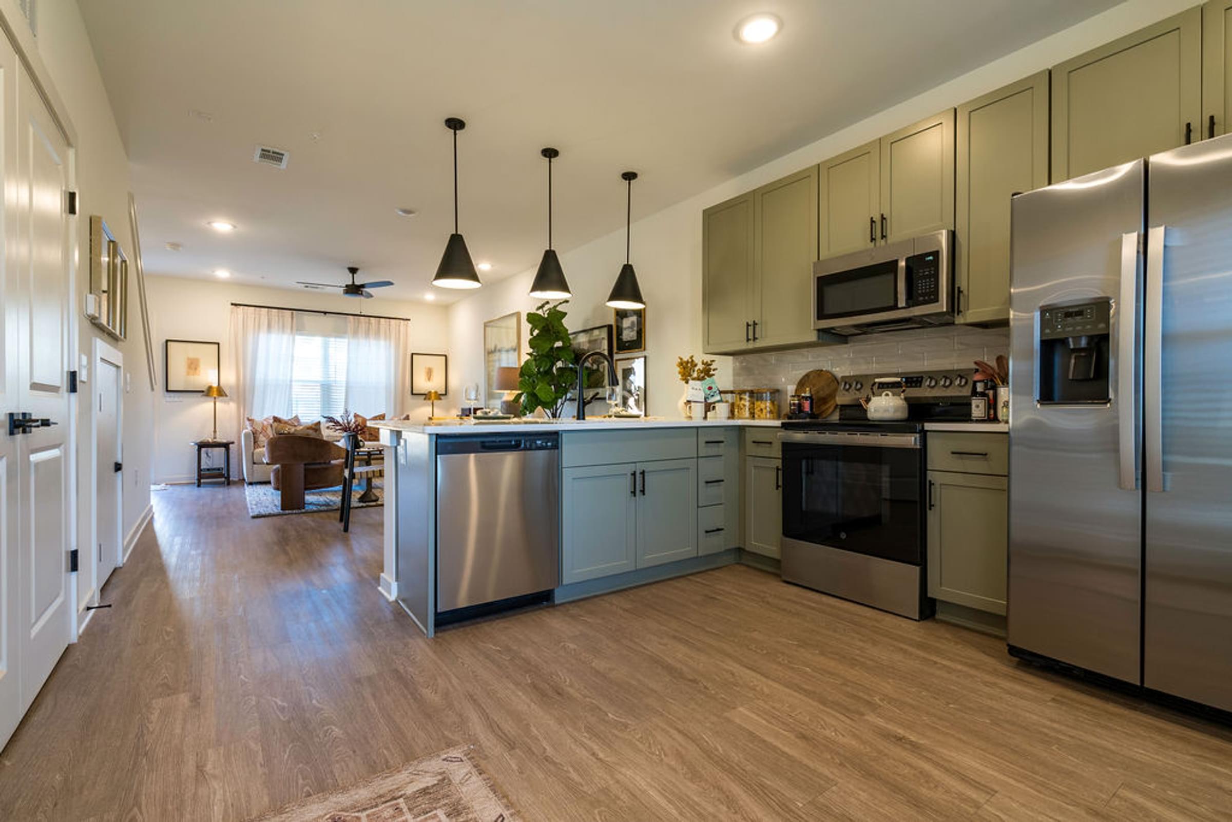 A kitchen with a refrigerator, stove, and oven.