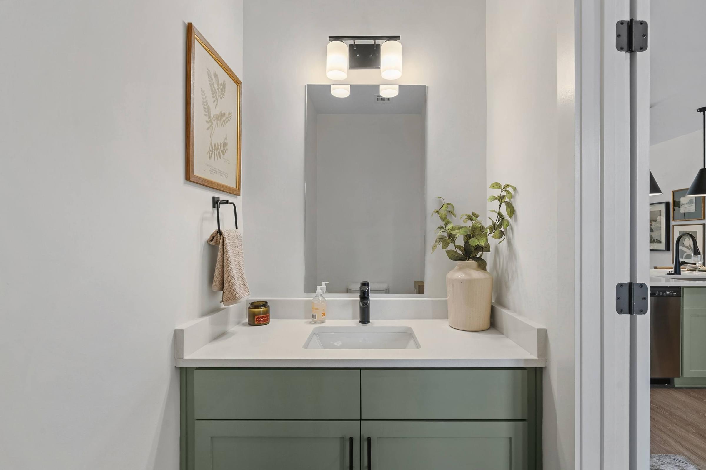 A bathroom with a sink and a mirror.