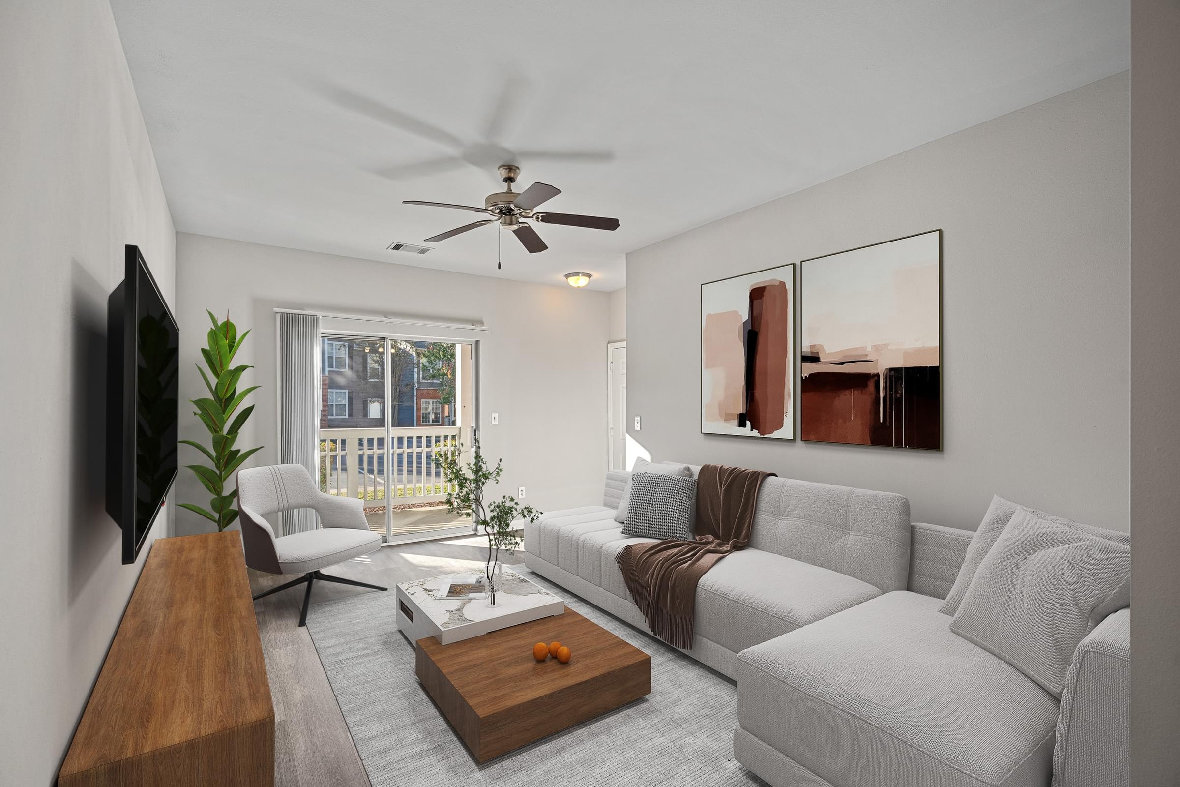 A living room with a grey couch and a wooden coffee table at Hawthorne Bridford in Greensboro, NC