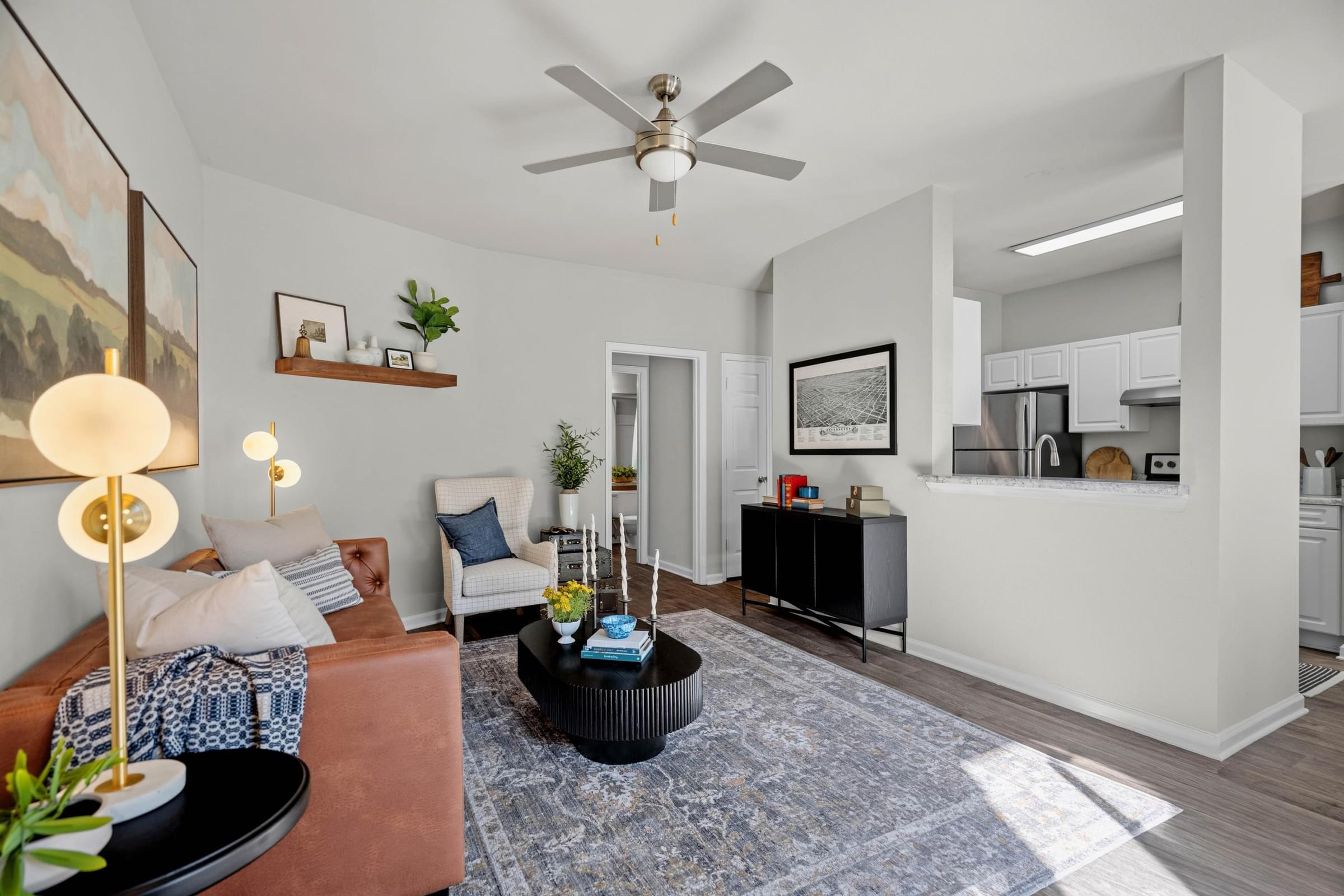 A living room with a ceiling fan and a couch.