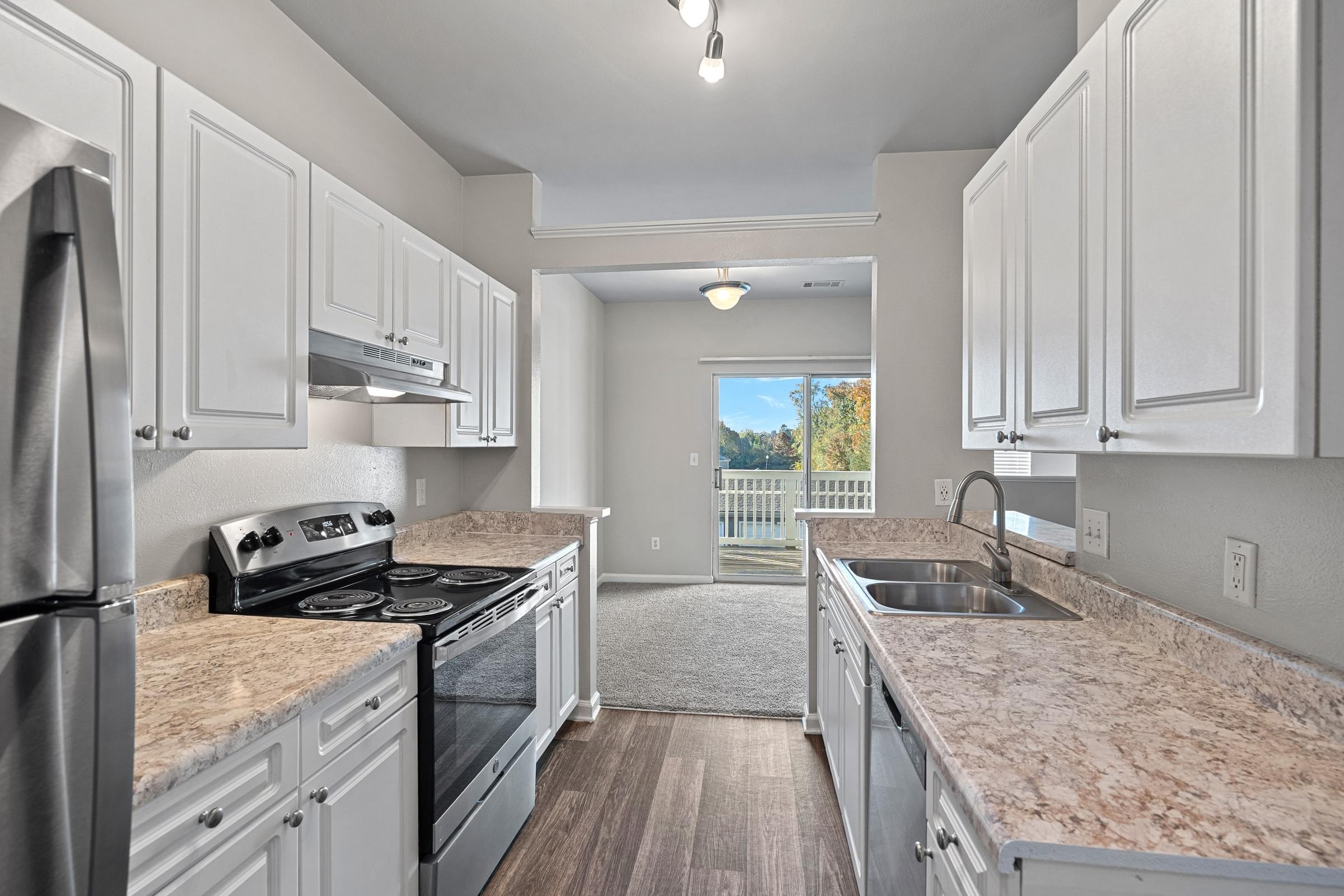 A kitchen with granite countertops and stainless steel appliances.
