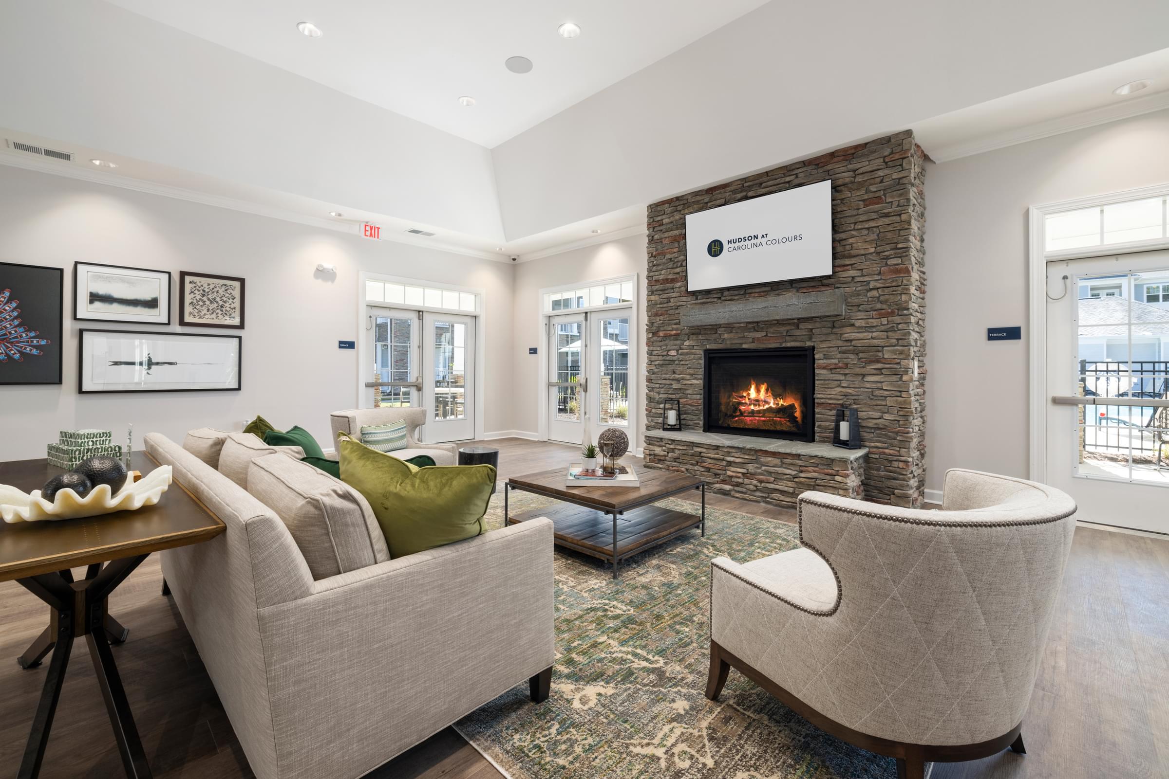 Side View of the Clubhouse Seating Area with Couch and Fireplace.