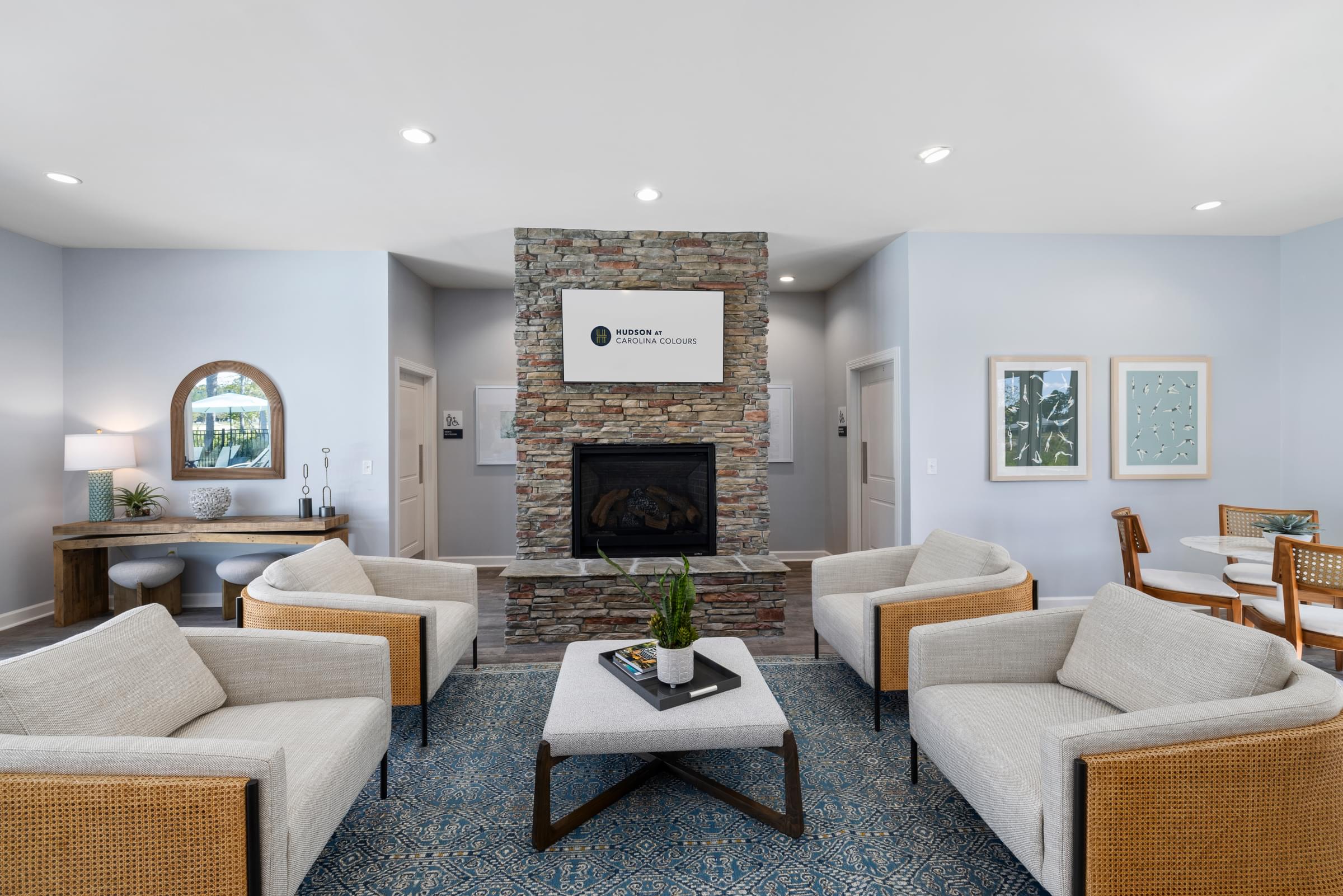 Clubhouse Seating Area with Chairs, a Fireplace and TV.