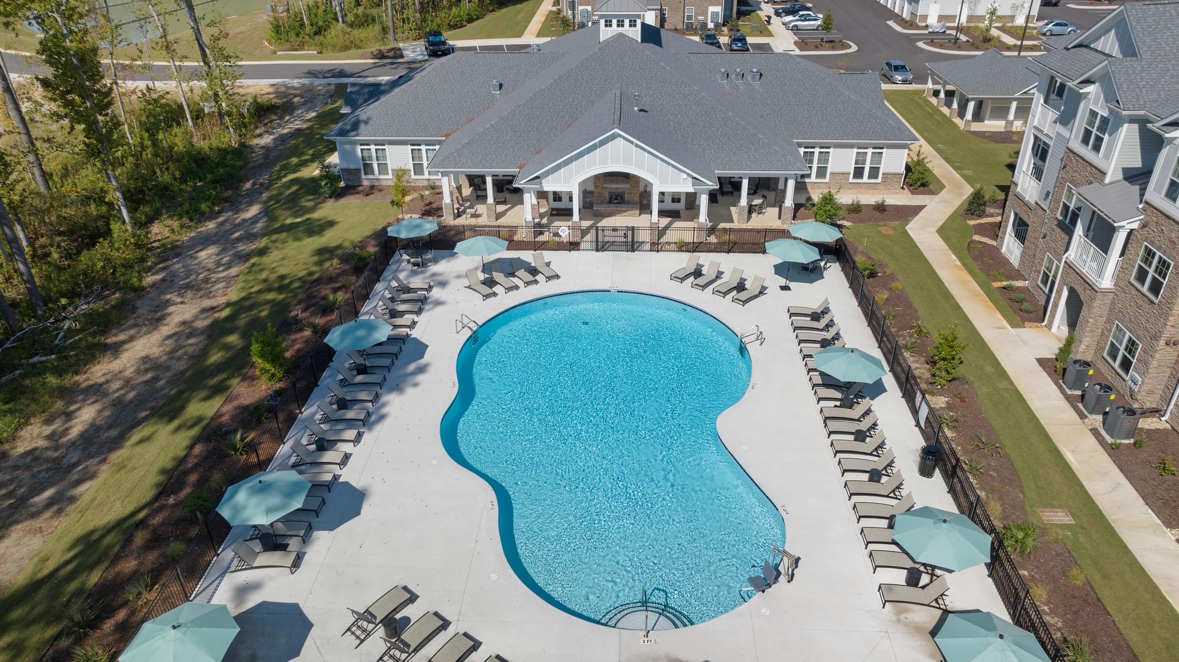 Aerial View of the Swimming Pool Surrounded by Lounge Chairs and Umbrellas.