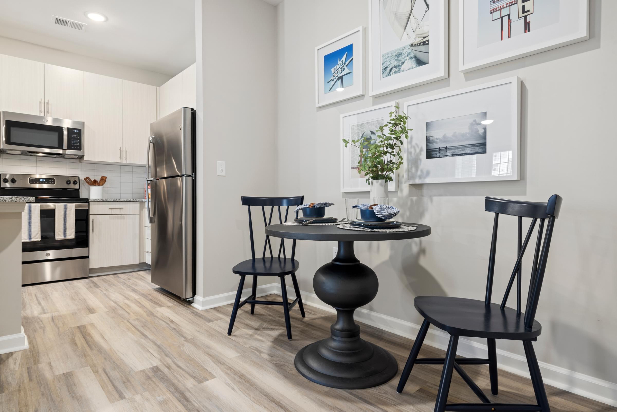 Eating Area with a Table and Two Chairs That are All Black.