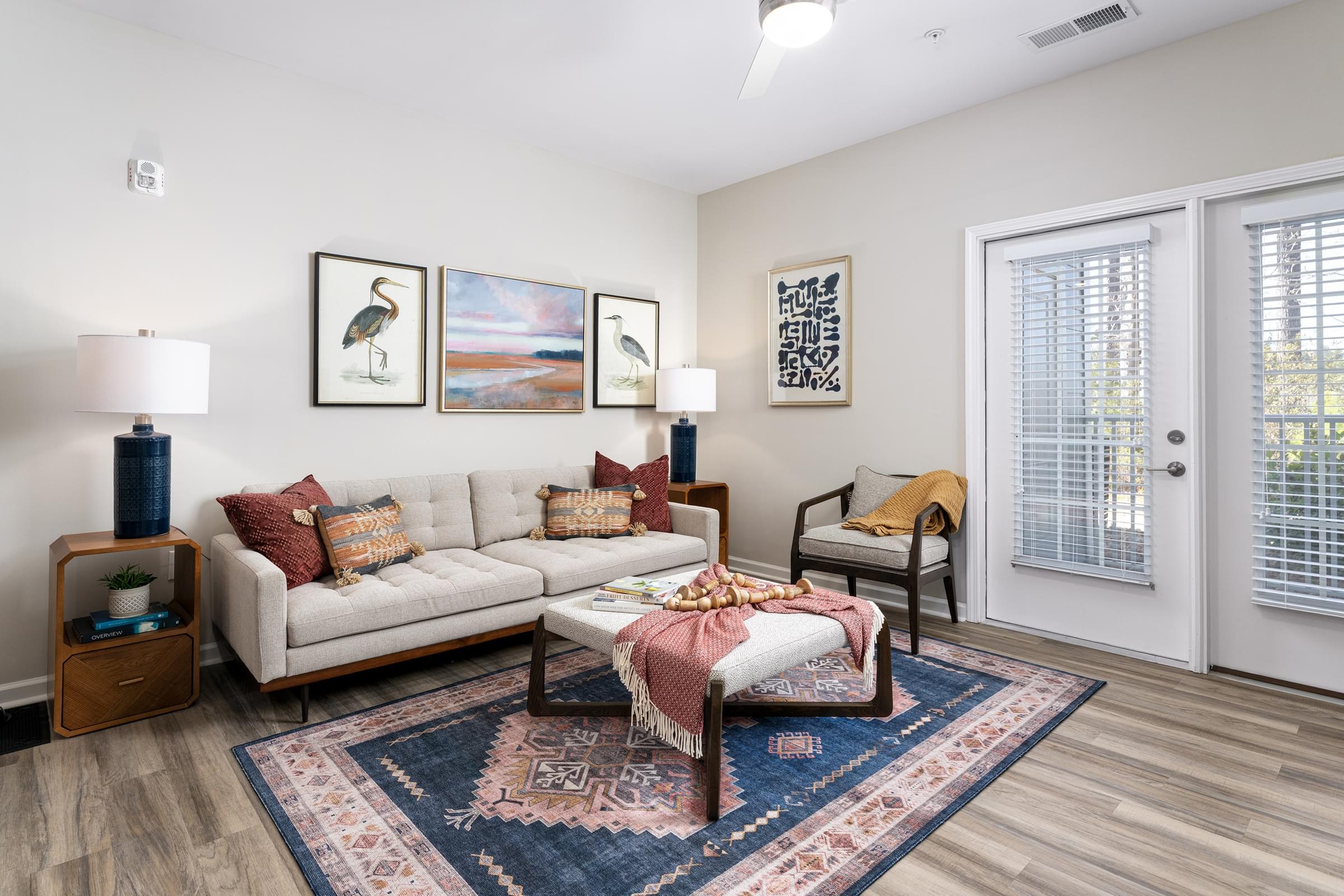 A living room with a couch, a coffee table, and pictures on the wall.