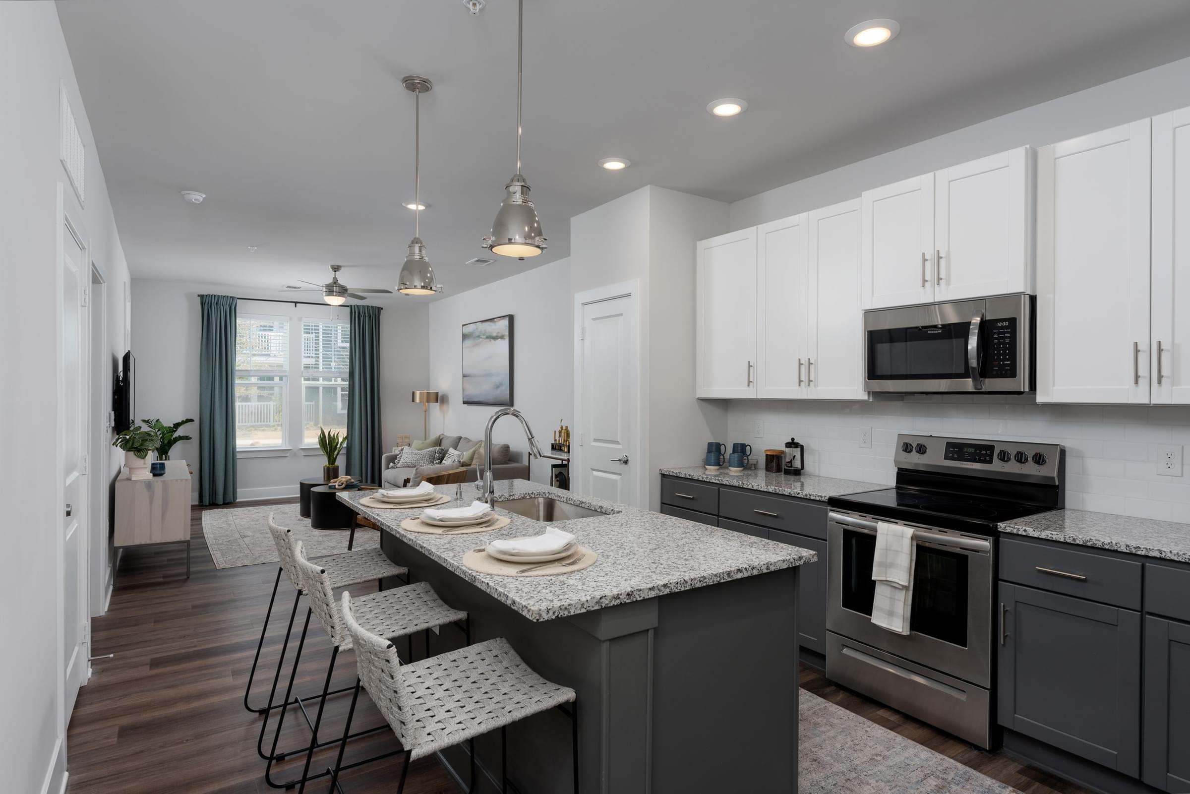 A kitchen with a large island and stainless steel appliances.