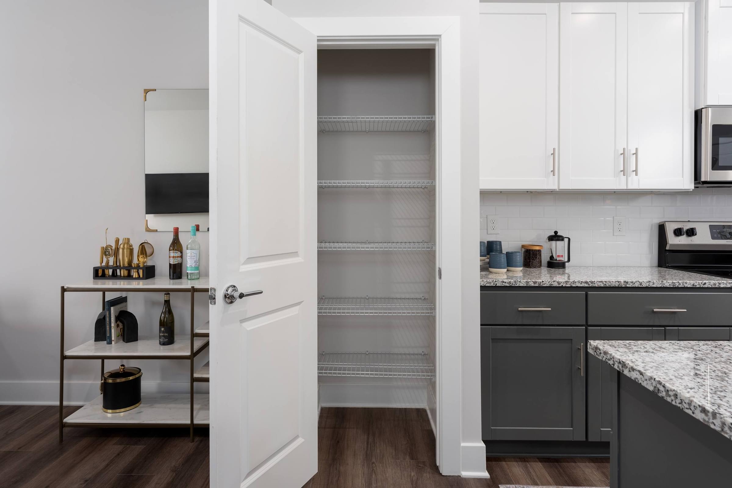 A kitchen with a white door and a wine rack.