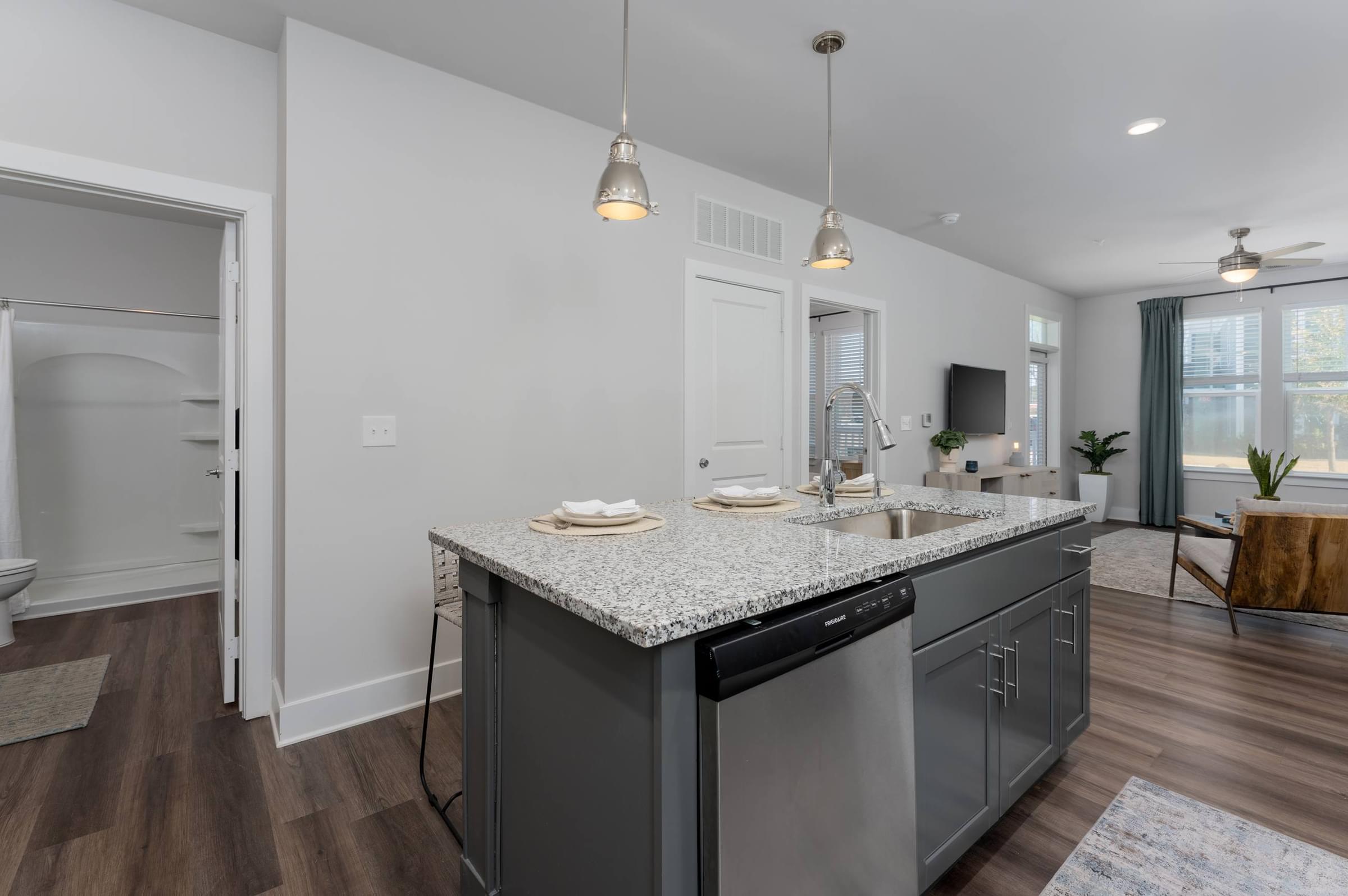 A modern kitchen with a large island and stainless steel appliances.