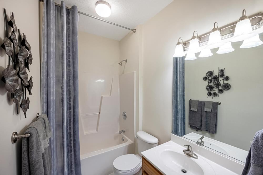 a bathroom with a shower and a sink and a toilet
