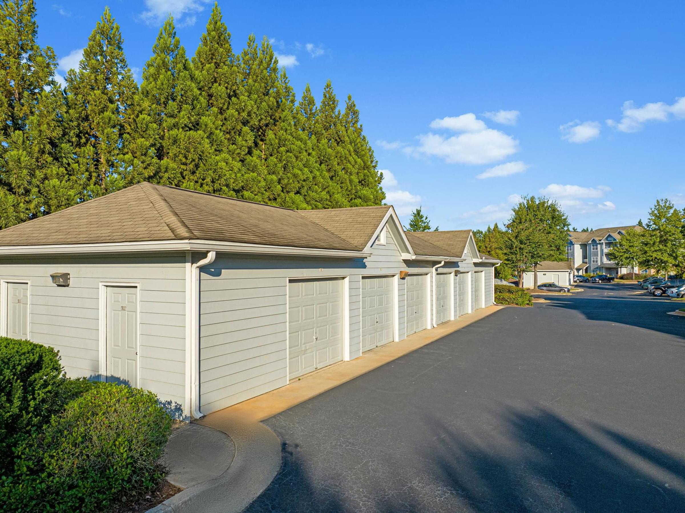 a row of white garages in a parking lot
