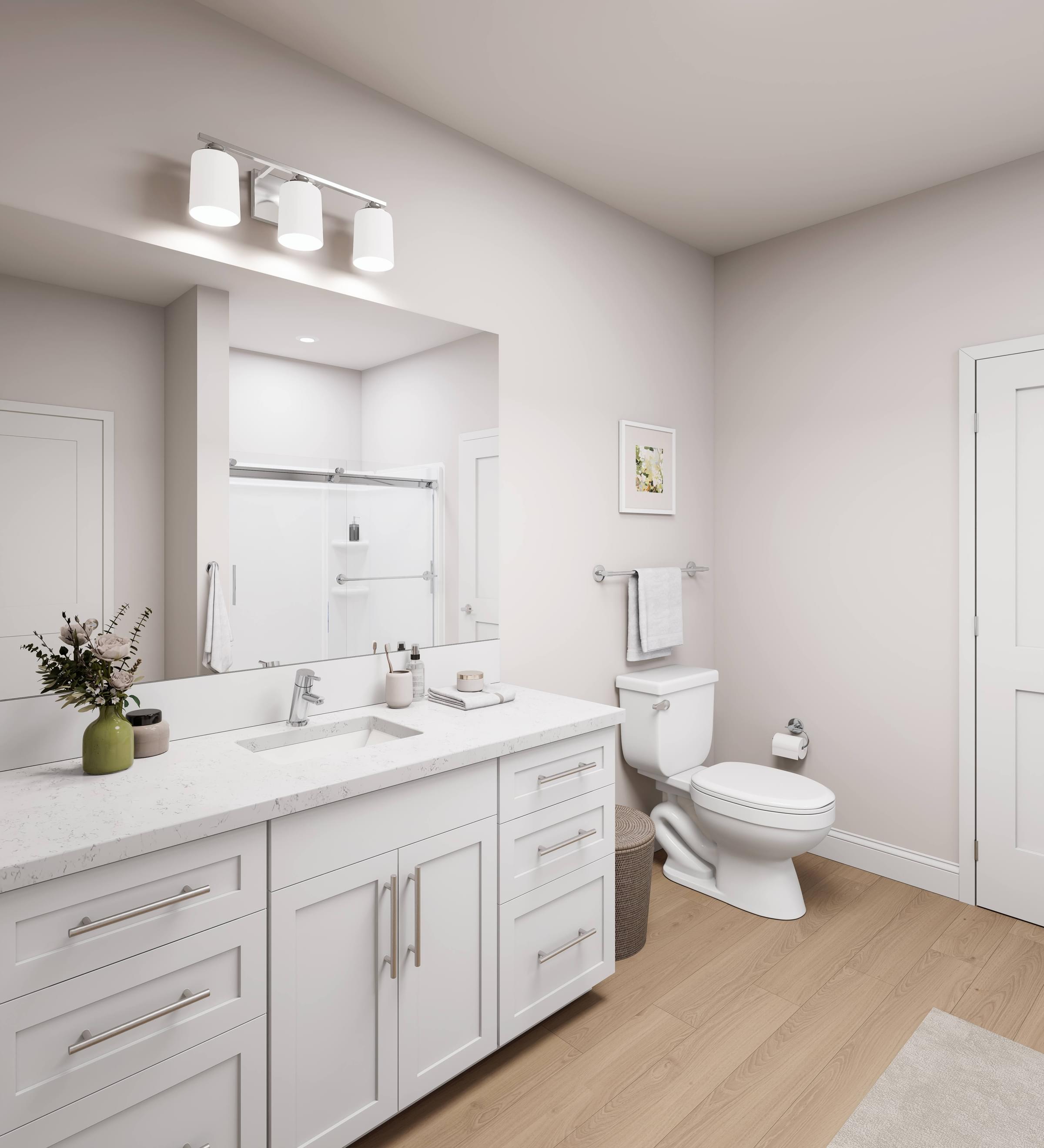 A white bathroom with a toilet, sink, and mirror.