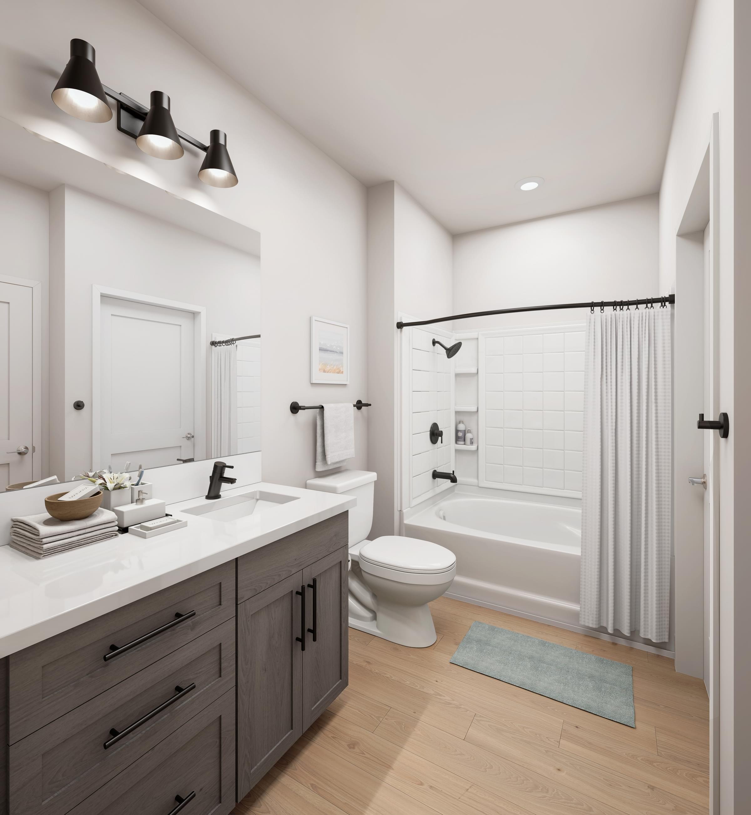 A modern bathroom with a white sink and a white toilet.
