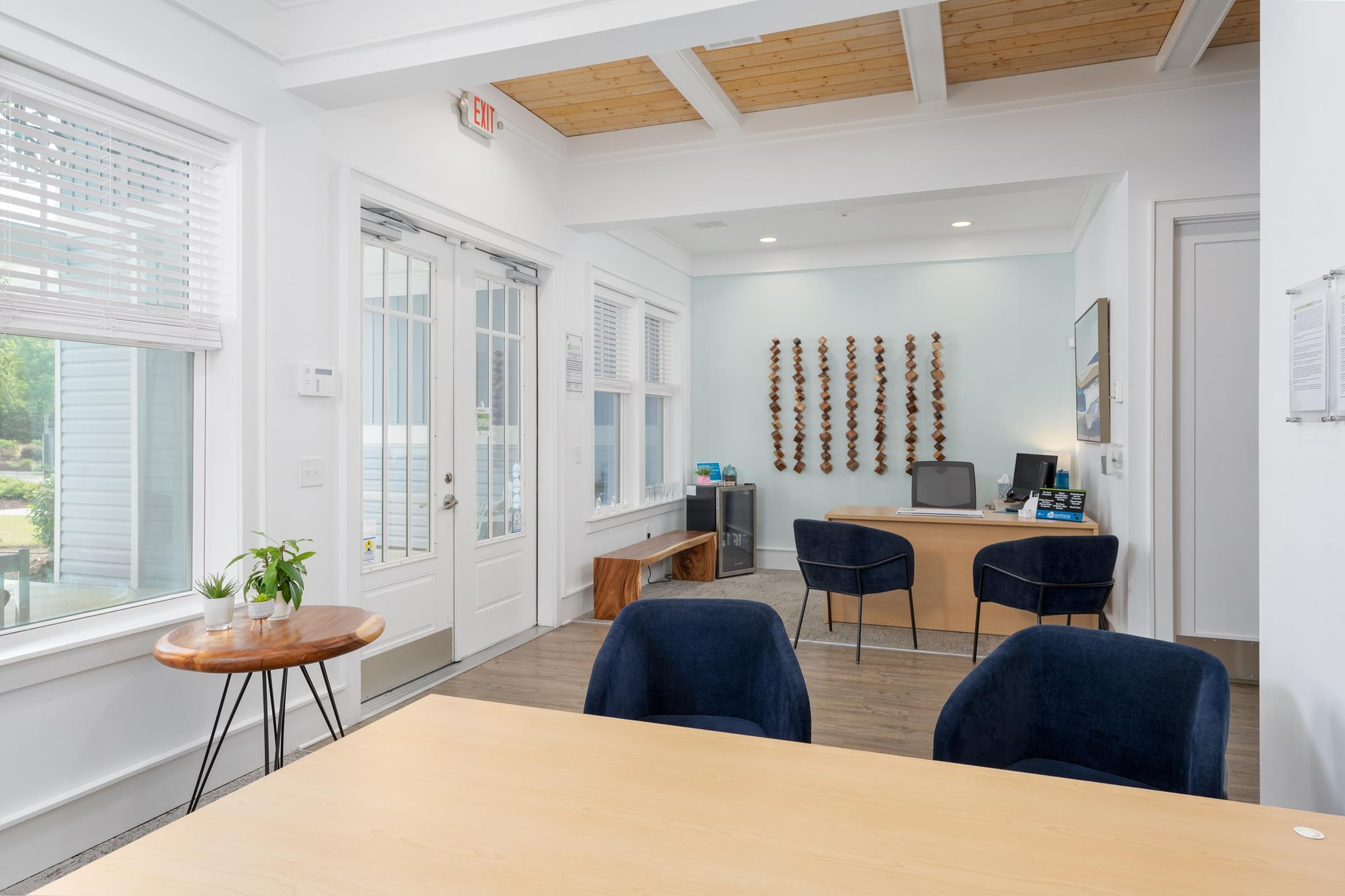A conference room with a long table and chairs.