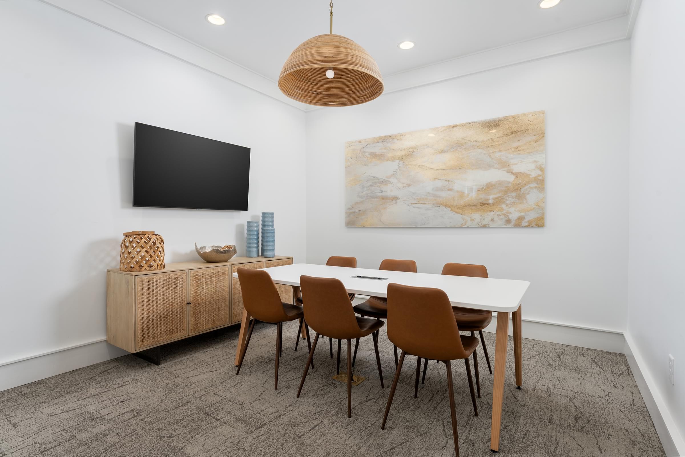 A modern dining room with a large table and chairs.