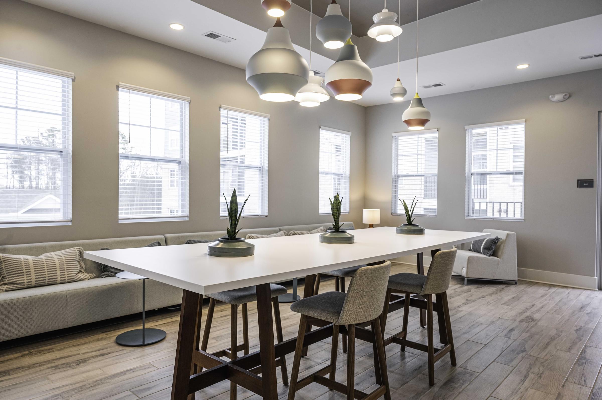 a conference room with a white table and chairs