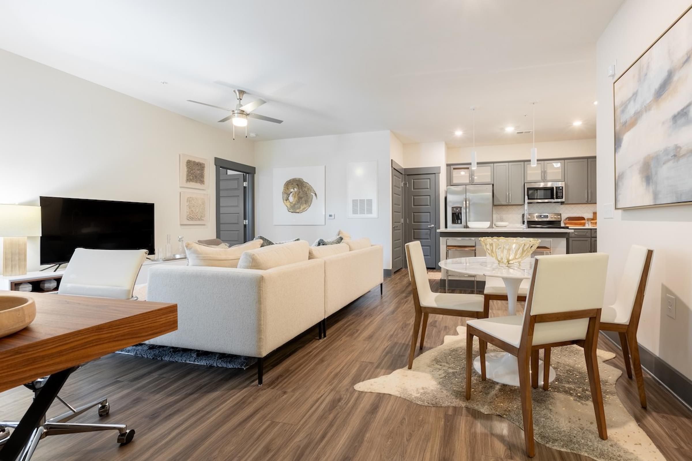 a living room with a couch and a table with chairs