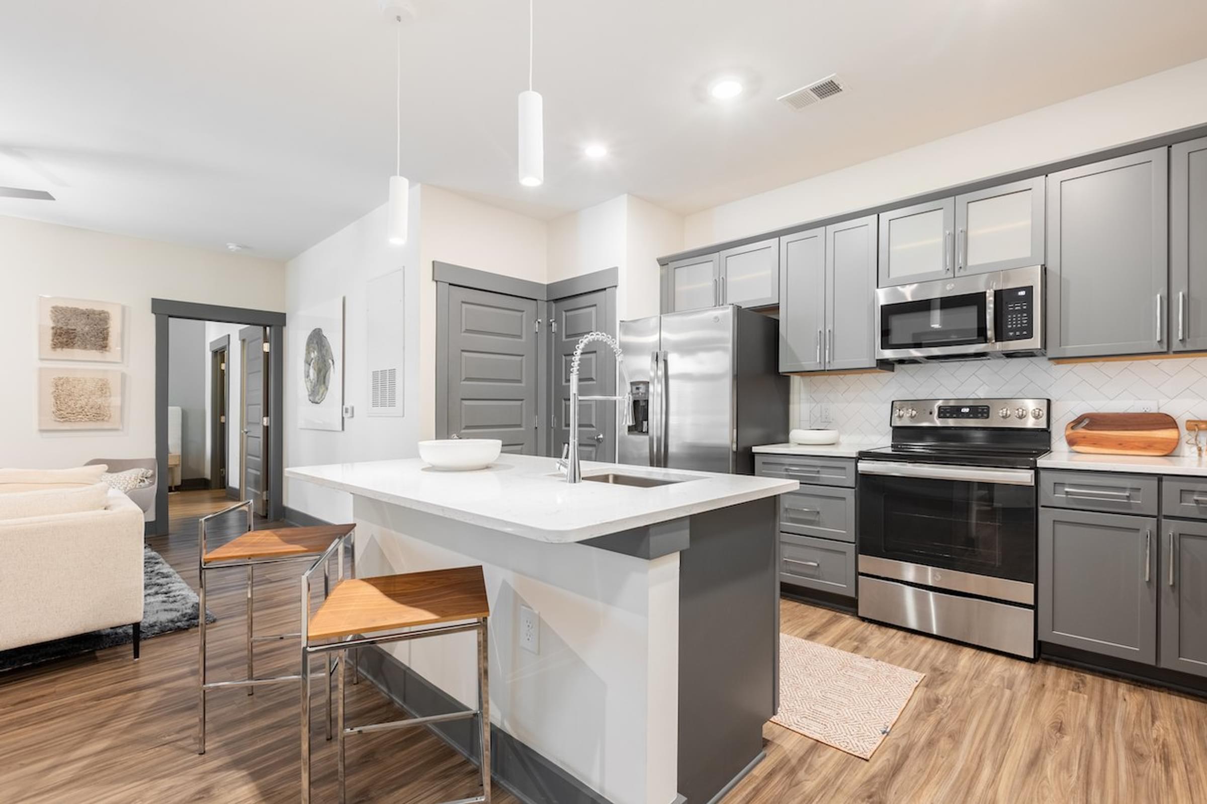 a kitchen with a large island and stainless steel appliances