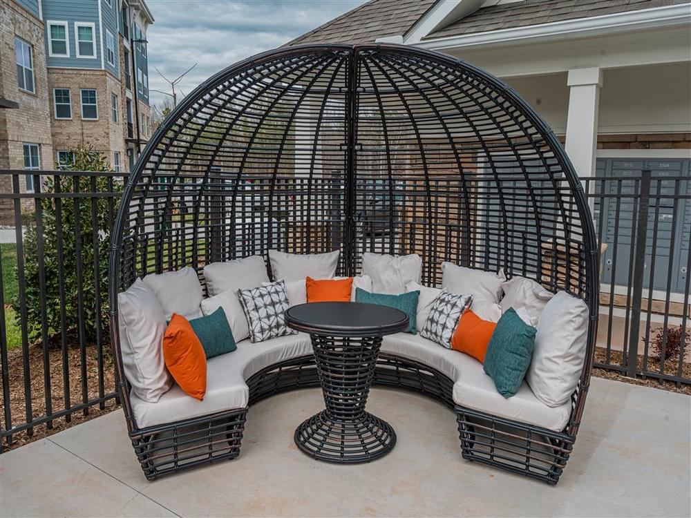 a gazebo with couches and a table on a patio