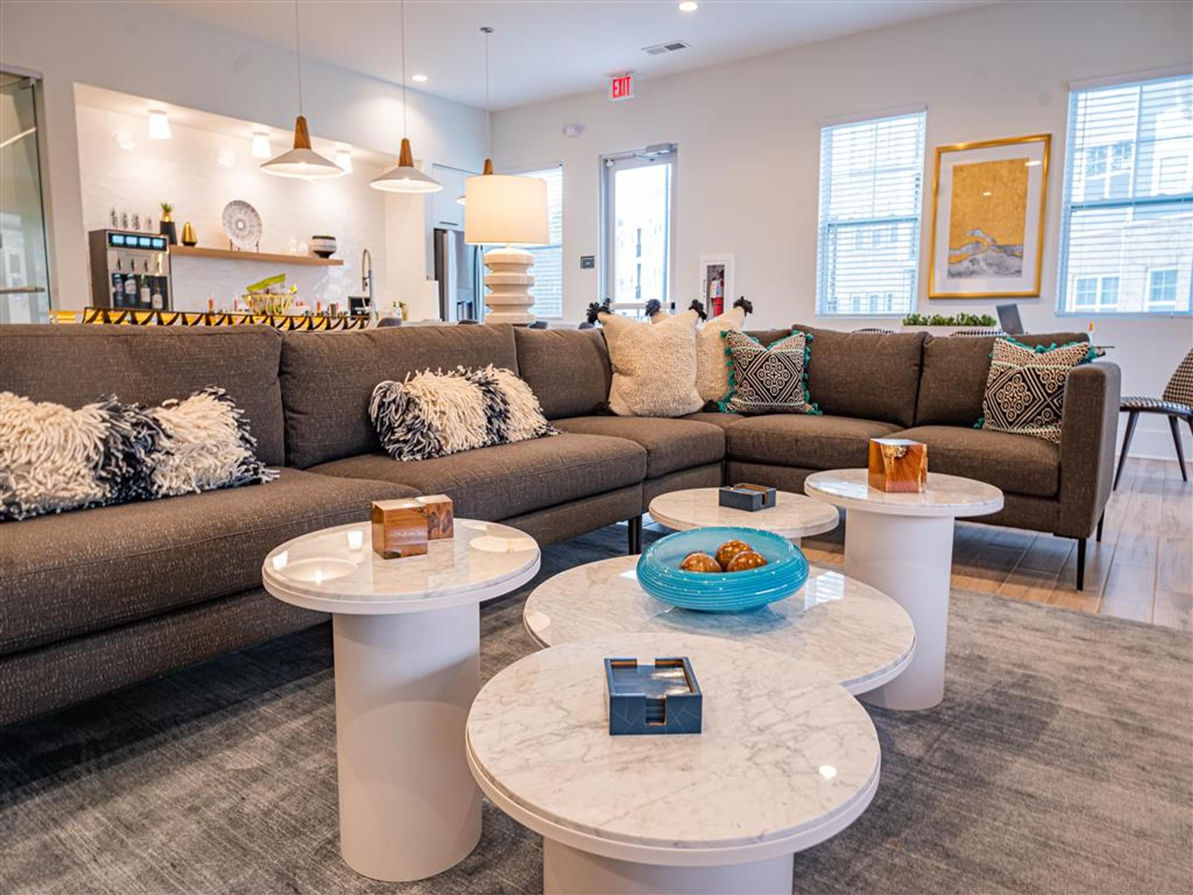 a living room with couches and round tables