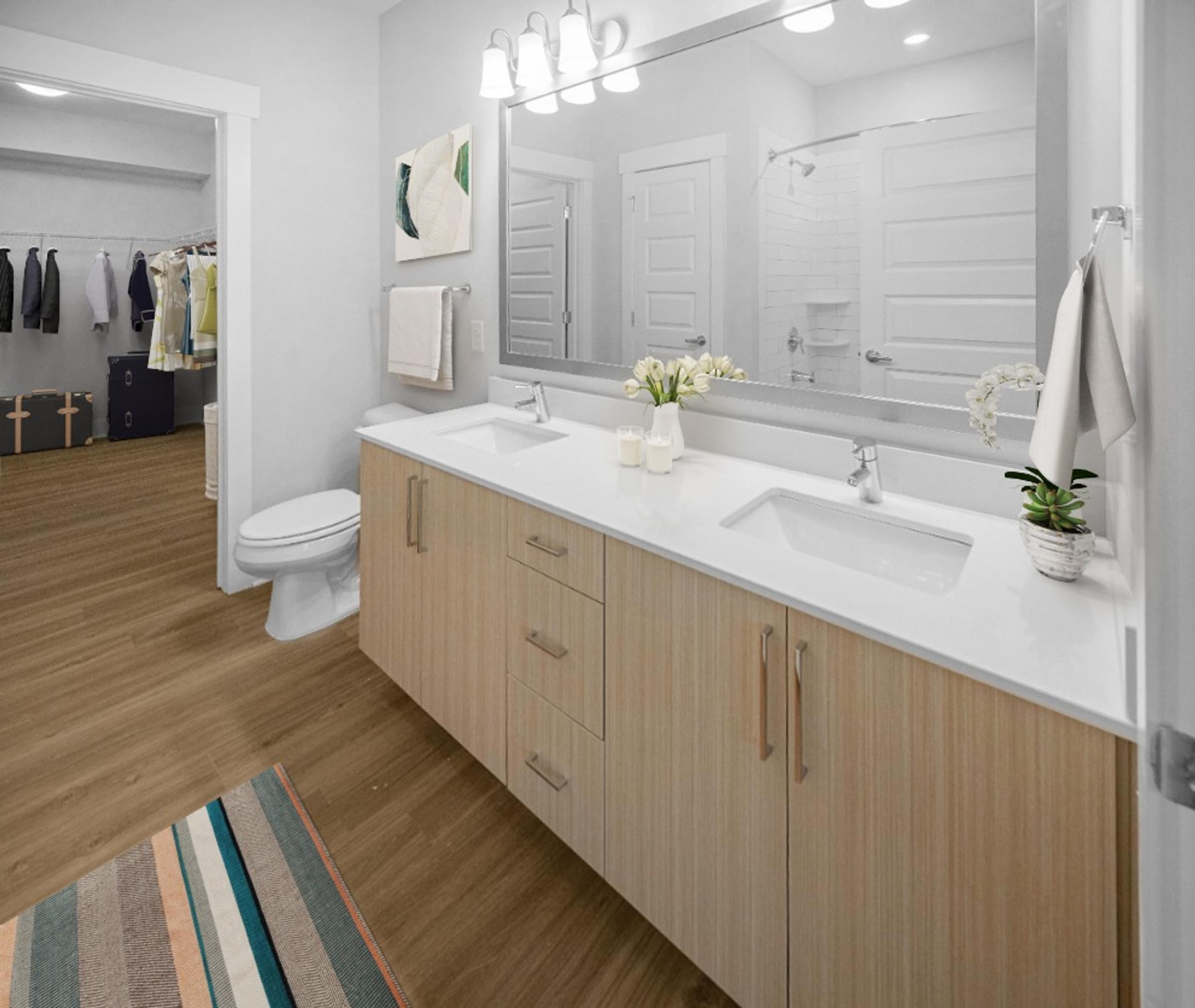 Modern Bathroom with Quartz Countertop, Dual Vanity Sinks, and Large Soaking Tub