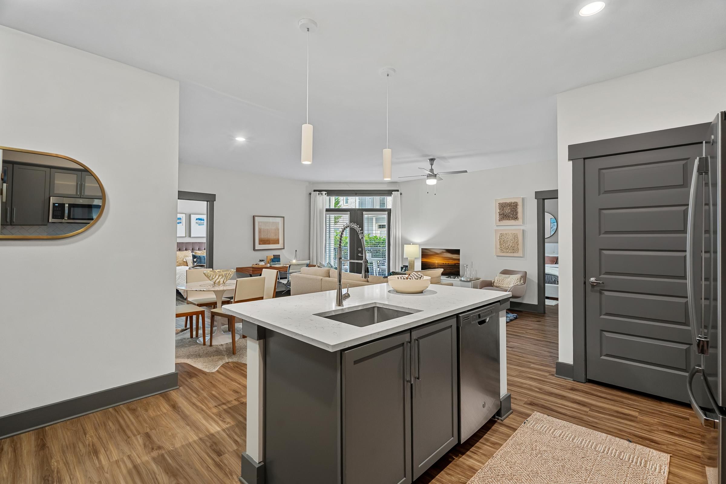 A modern kitchen with a large island and a sliding door.