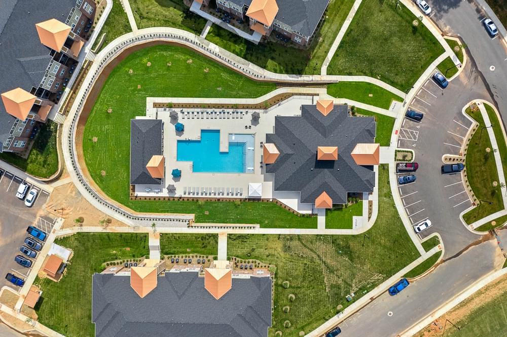 arial view of a mansion and its backyard with a swimming pool