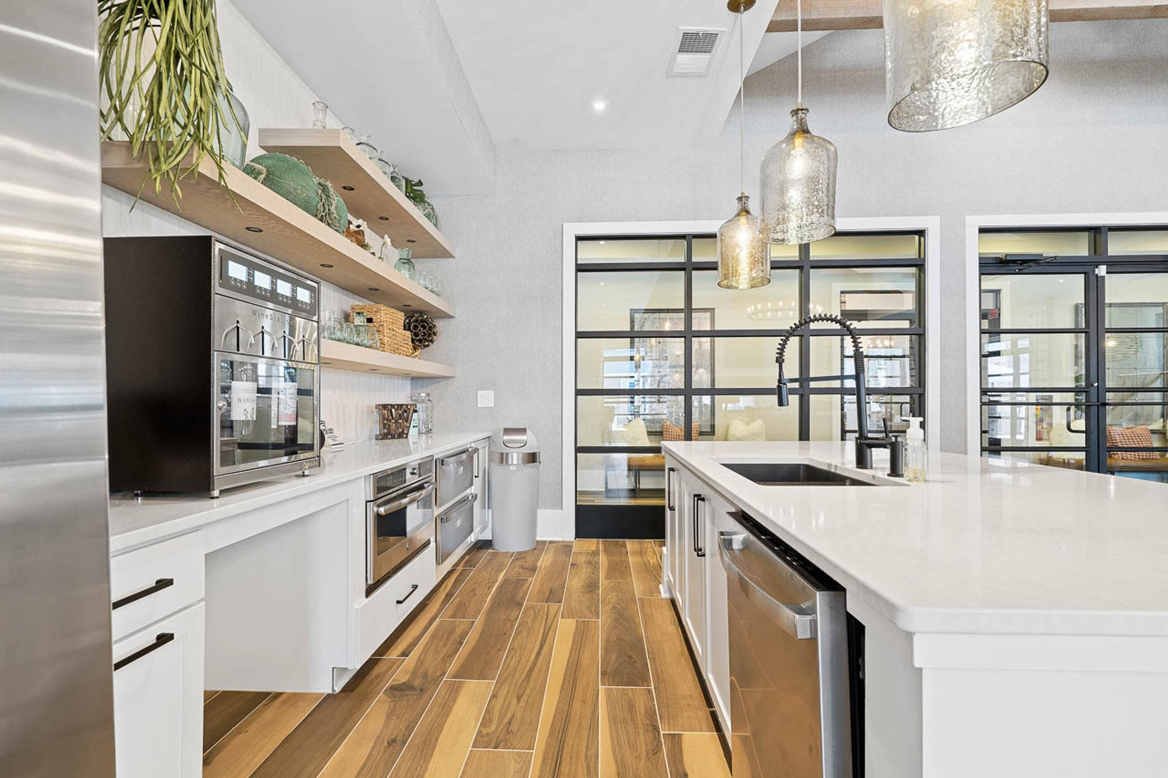 a large white kitchen with a sink and a window