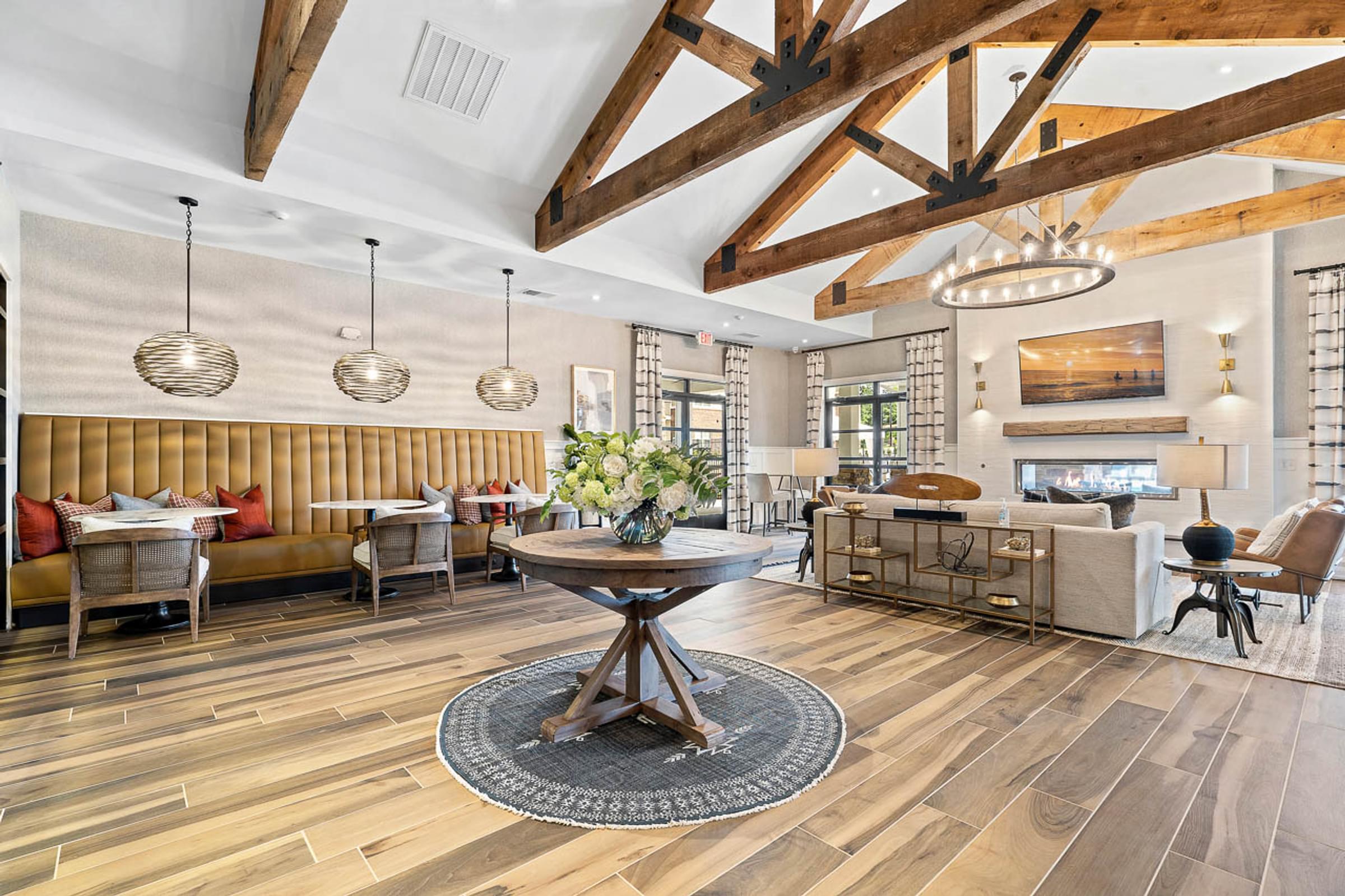 a living room with exposed beams and a table