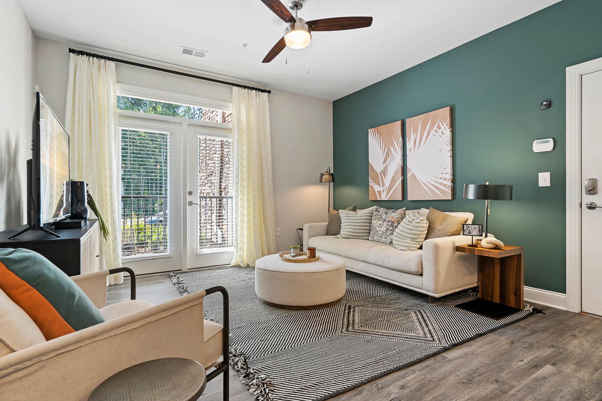 a living room with a couch and a ceiling fan