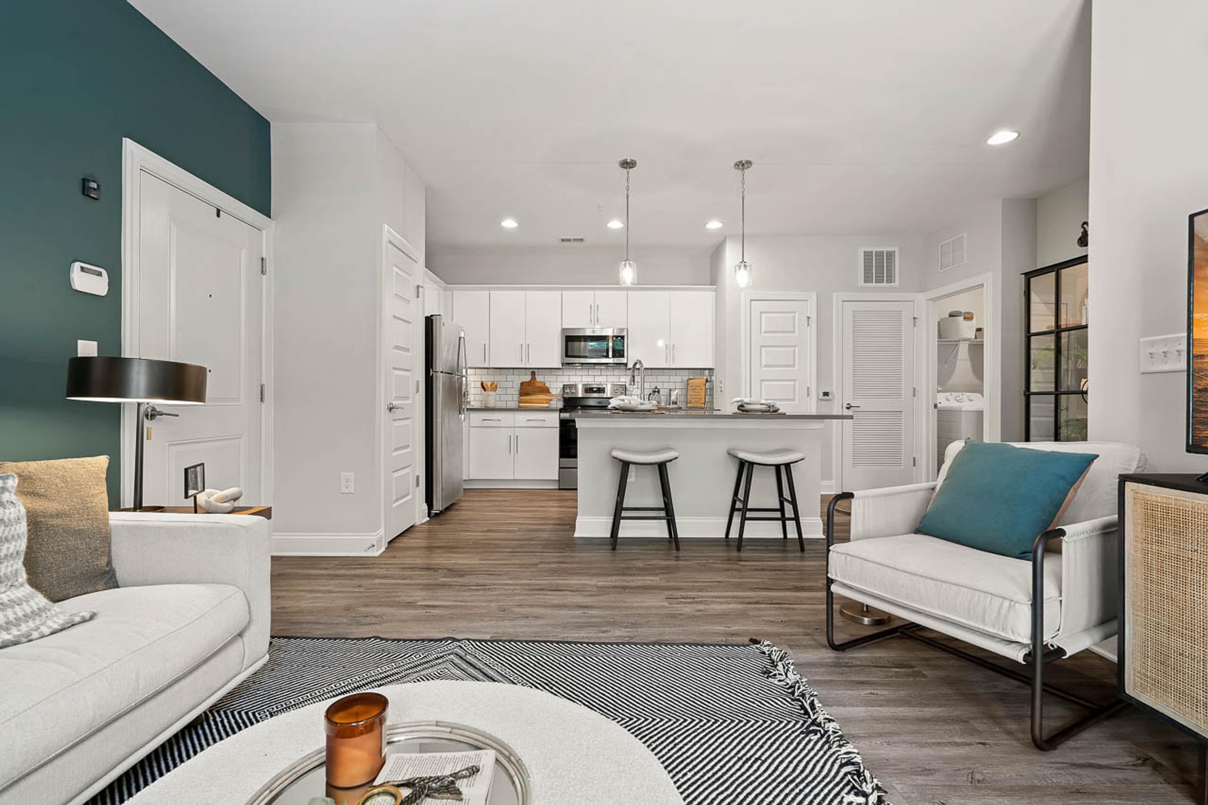 a living room and kitchen with a couch and a table