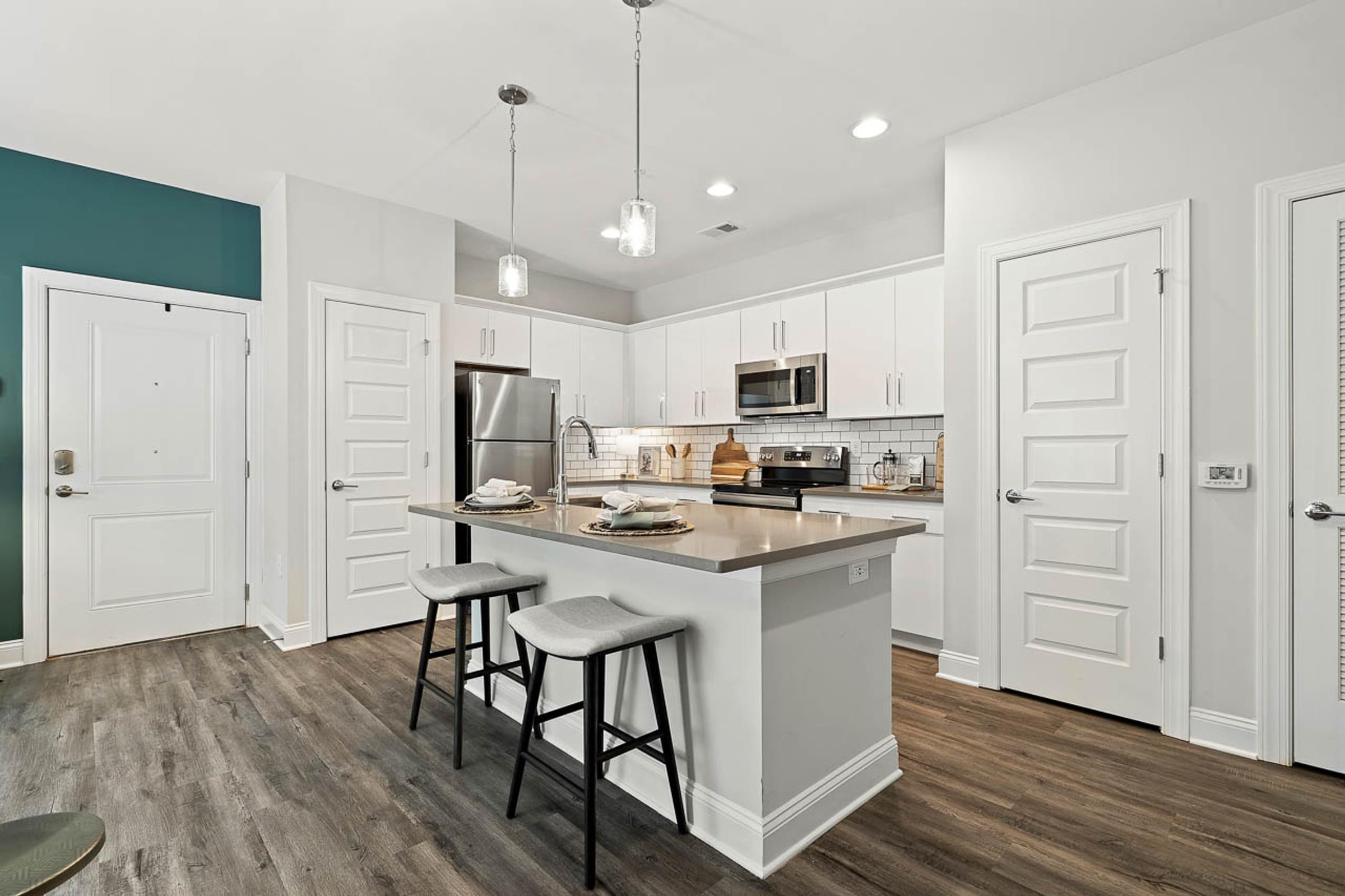 a kitchen with an island and stools