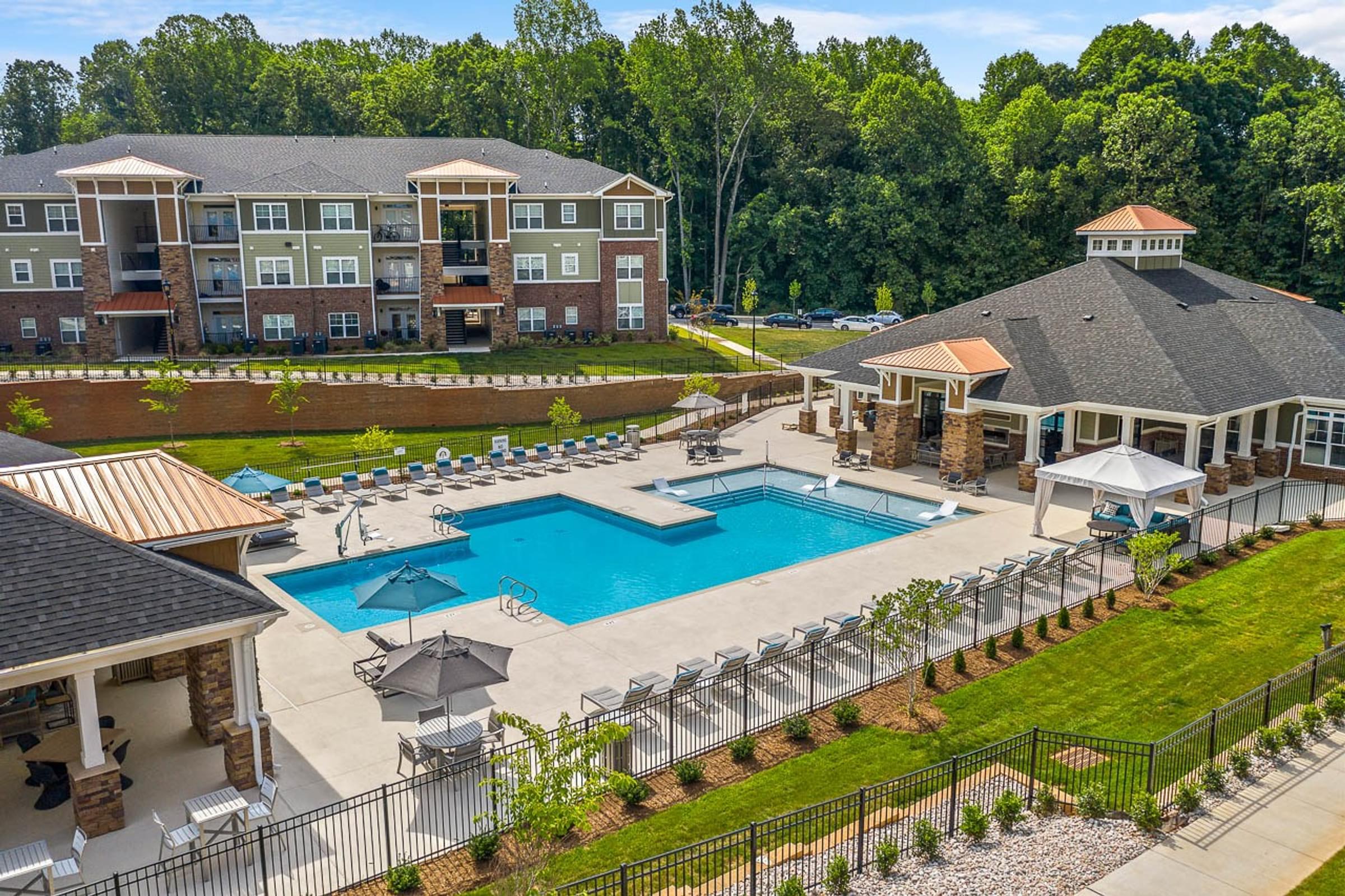 Amenities luxurious pool with small fountains, lounge seating, and cabanas