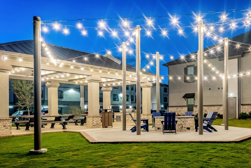 our outdoor patio is lit up at night with lights on our pavilion
