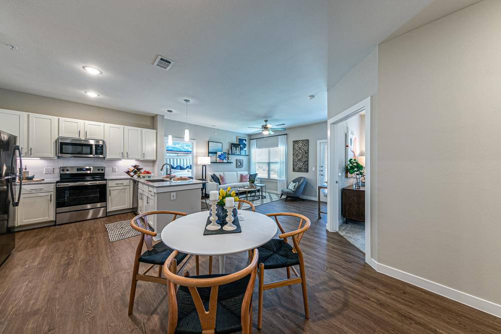an open kitchen and dining area with a table and chairs