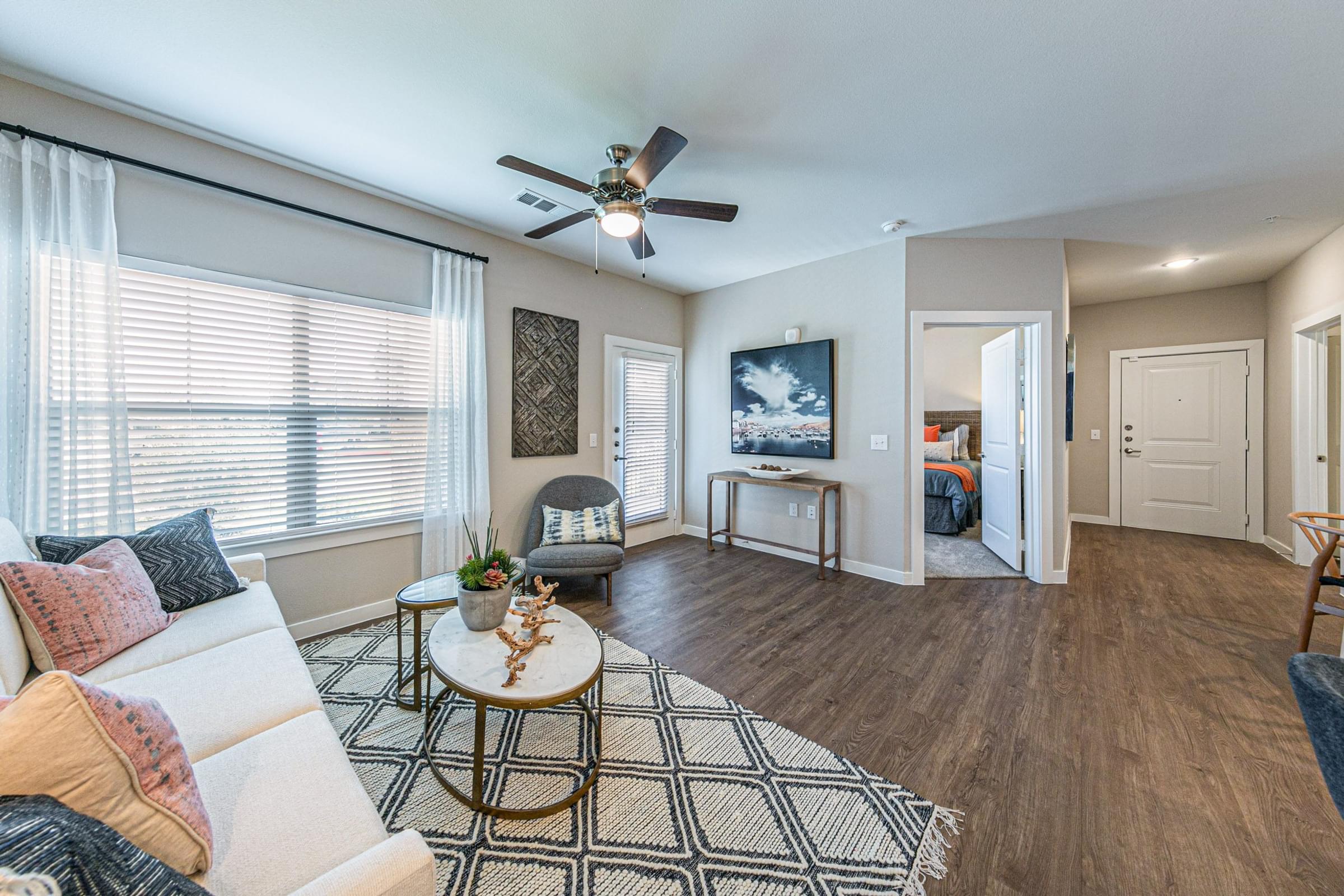 a living room with a couch and a ceiling fan