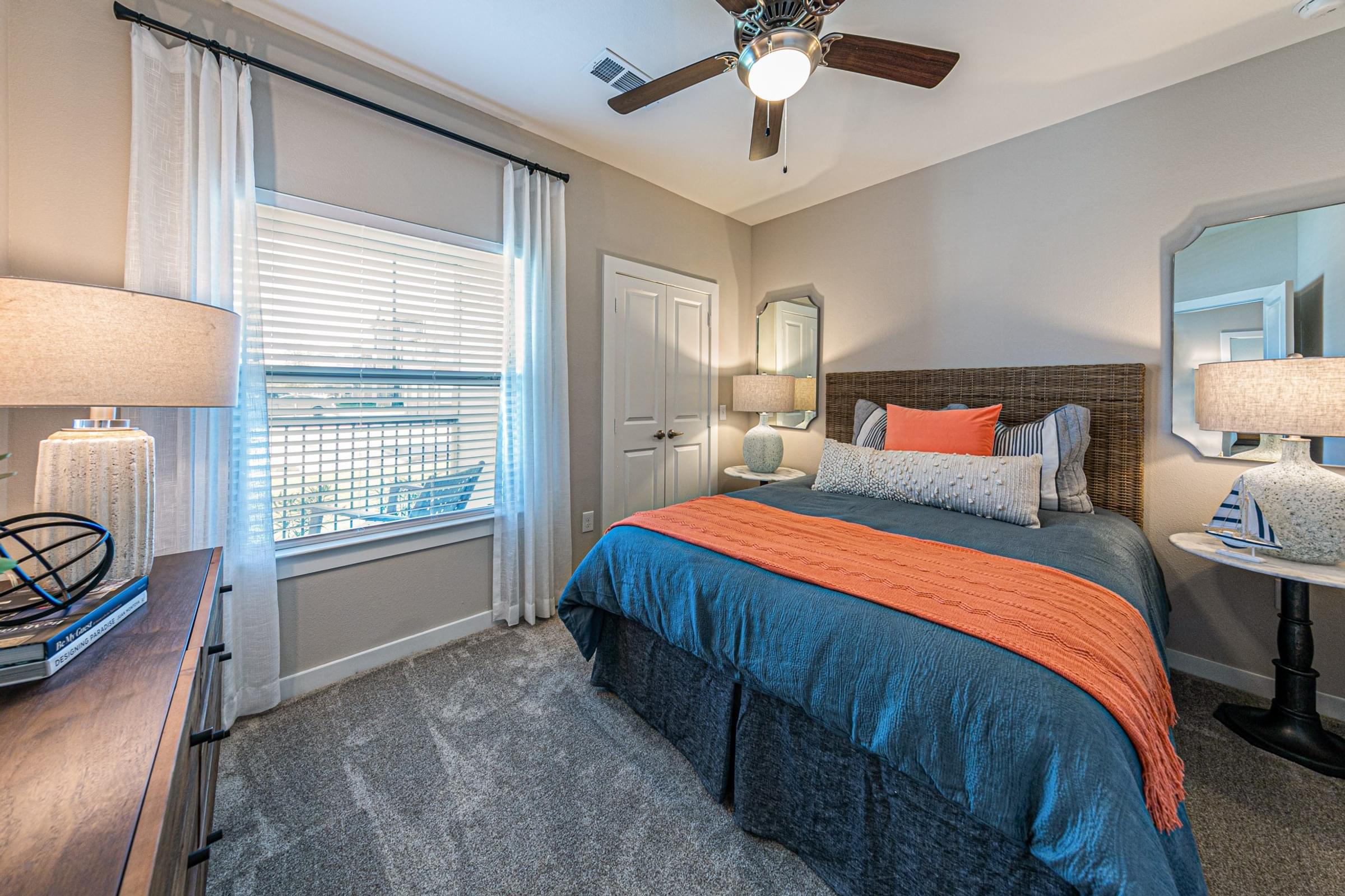 a bedroom with a bed and a ceiling fan