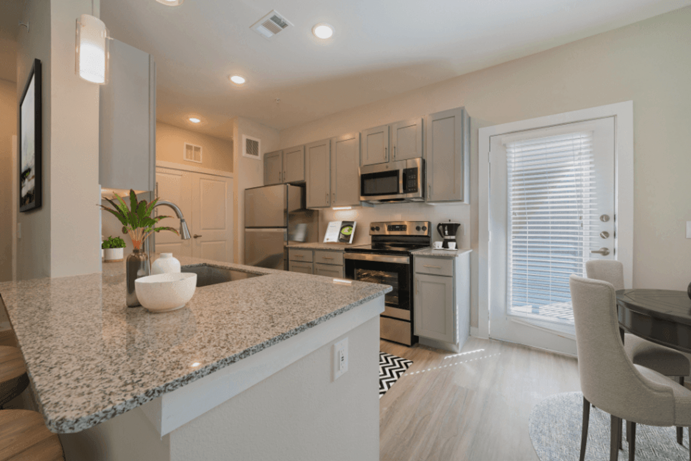 a kitchen with a granite counter top and a sink