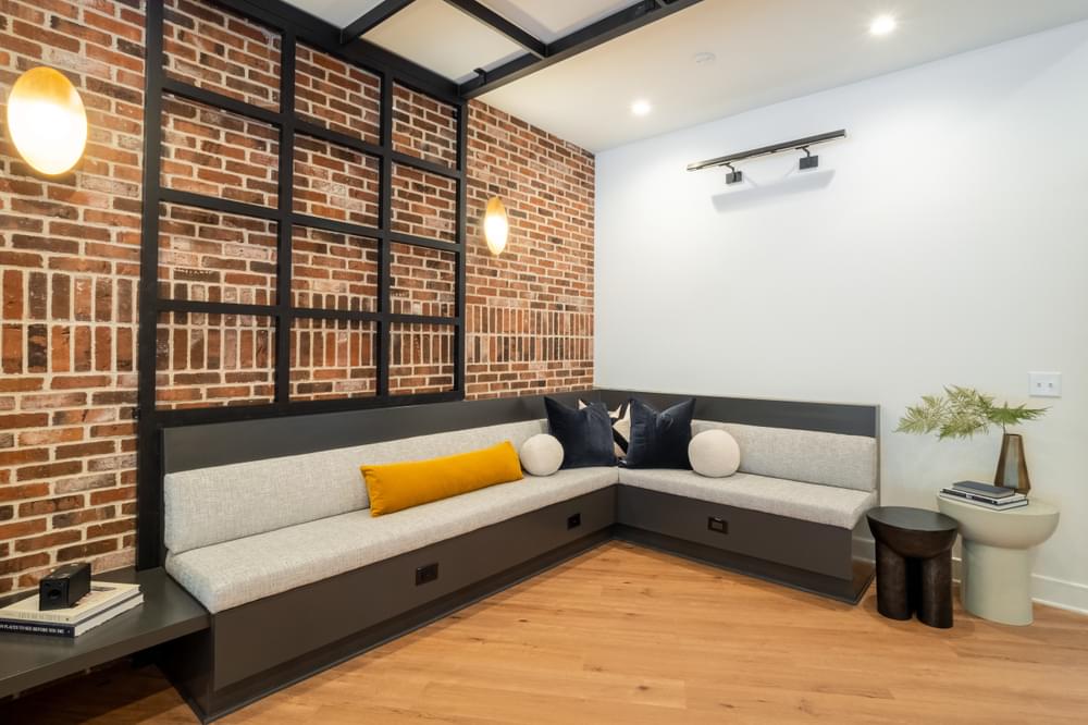 a living room with a brick wall and a couch