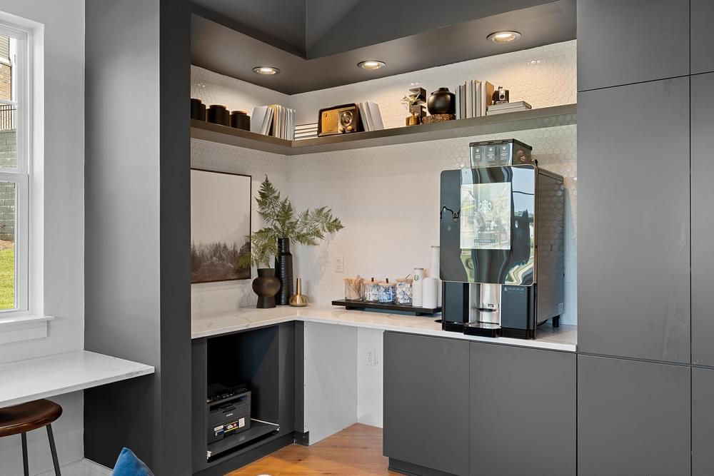 a kitchen with grey cabinets and a coffee machine