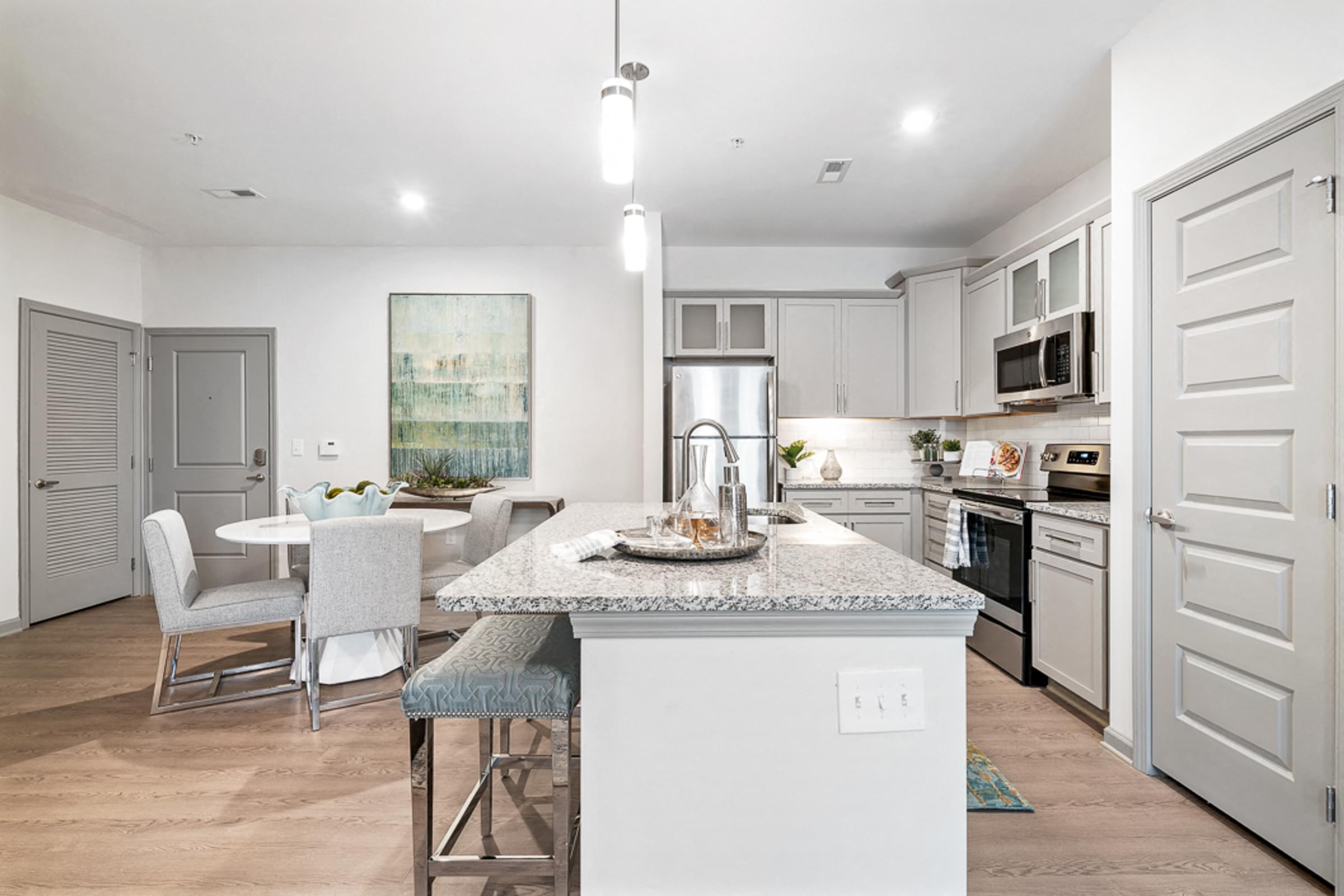 Designer Kitchen with Stand-Alone Island and Breakfast Bar, Granite Countertops, and Frosted Glass Cabinets