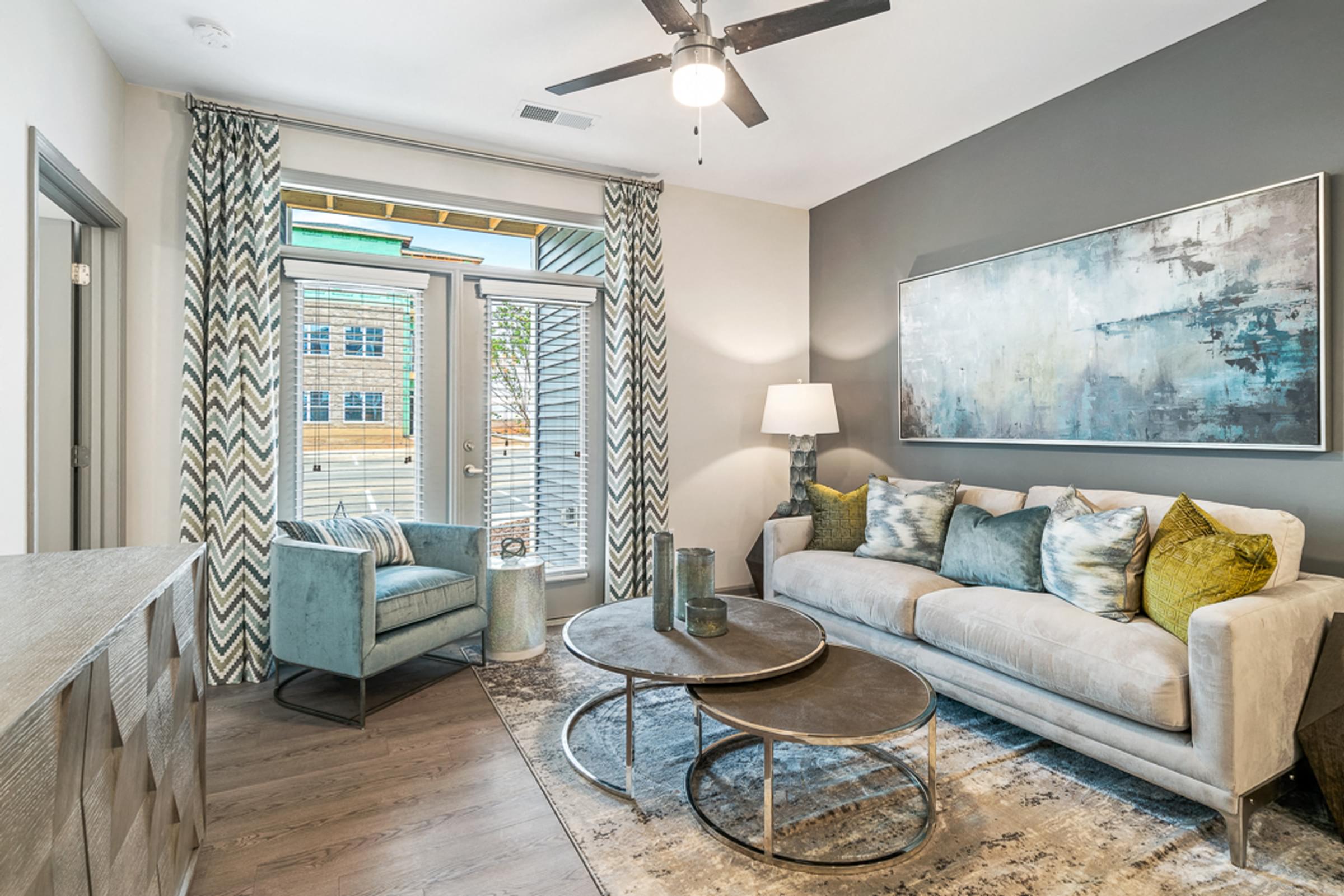 Spacious Living Room with Ceiling Fans, USB Charging Ports, and Private Balcony