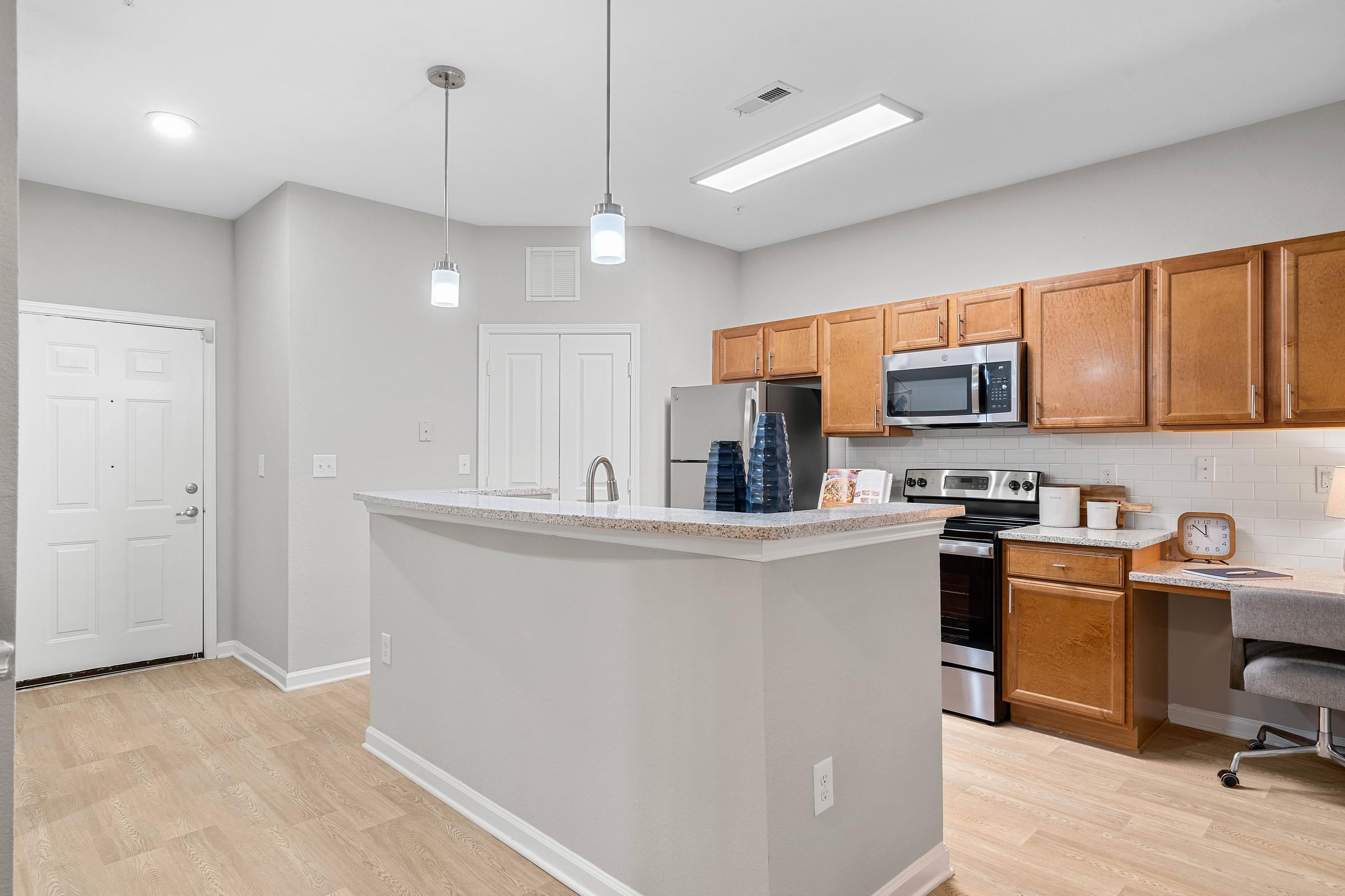 an open kitchen with a large island with a counter top