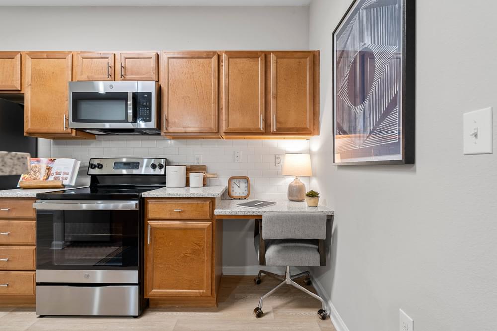 our apartments have a kitchen with a desk and a microwave