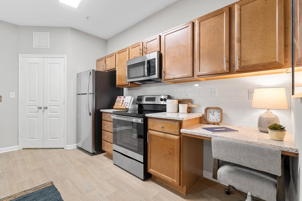 our apartments offer a kitchen with stainless steel appliances and wooden cabinets