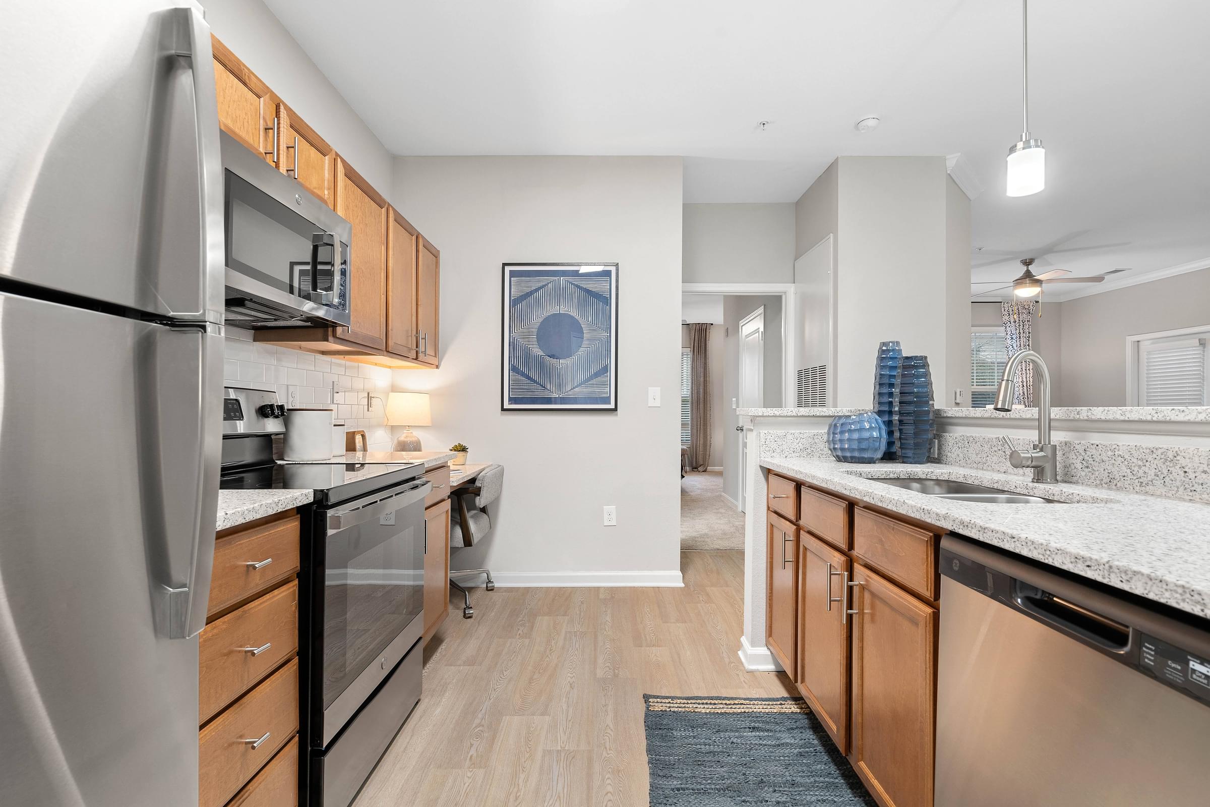 Modern Kitchen with Stainless Appliances and White Granite Counterops