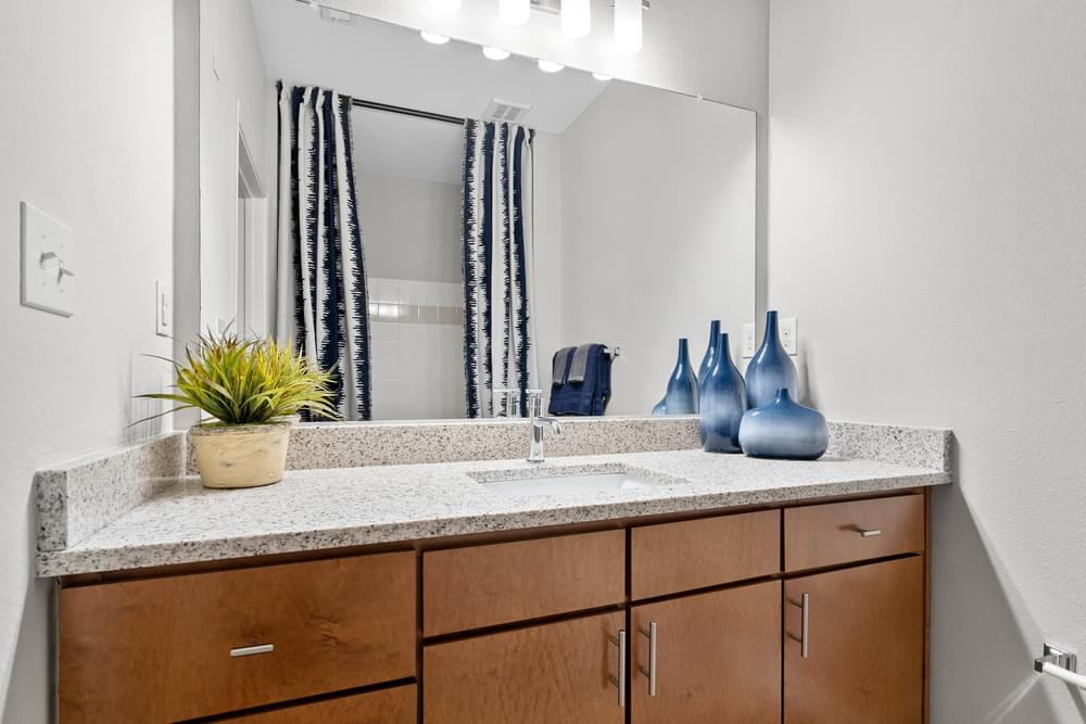 our apartments offer a bathroom with a sink and a mirror